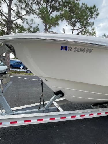 2014 Everglades 325 Center Console boat on trailer, parked outdoors.