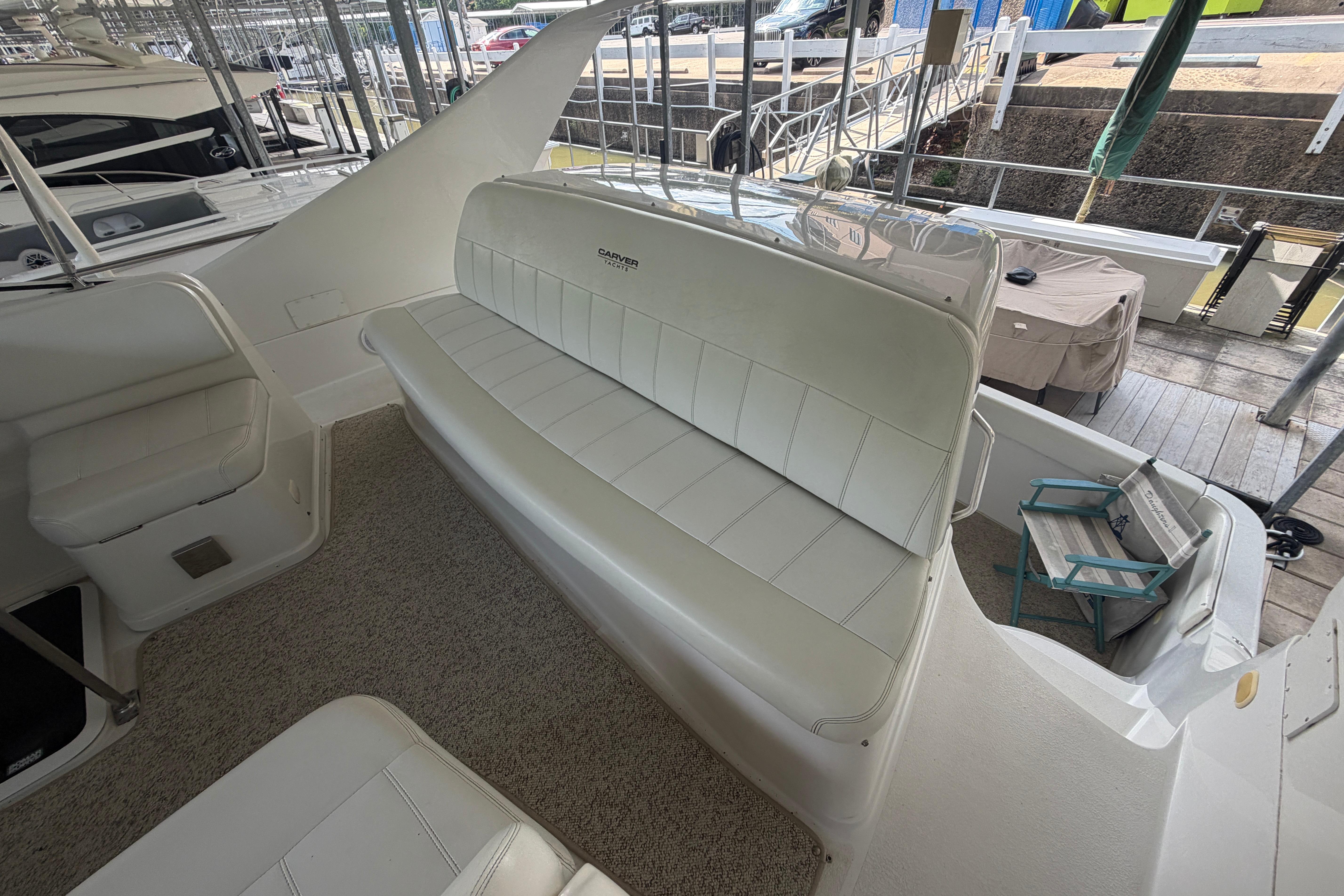 2000 Carver 350 Mariner boat interior with white seating and carpeted flooring.