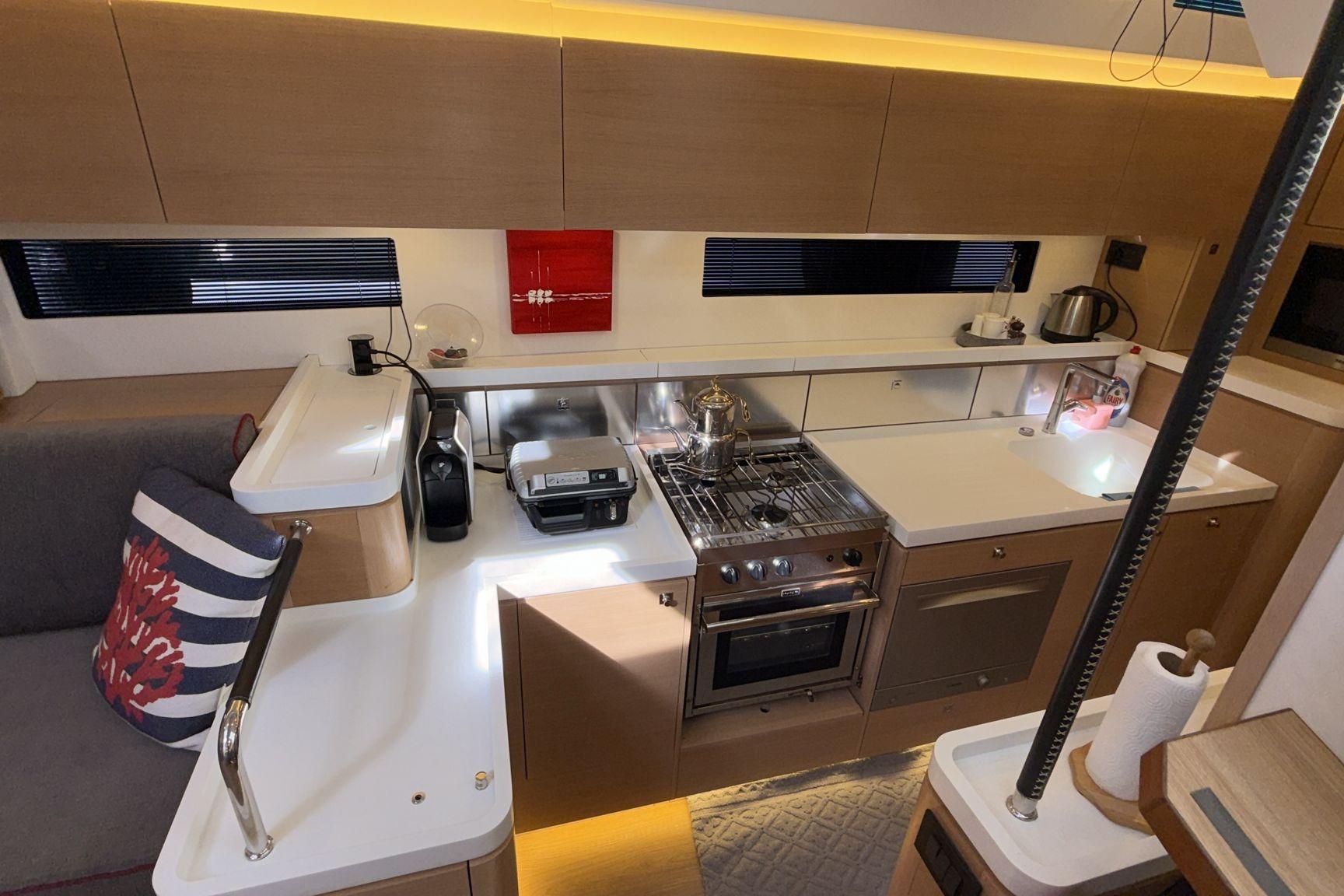 Modern kitchen interior on a 2019 Amel 50 yacht, featuring sleek cabinetry and appliances.