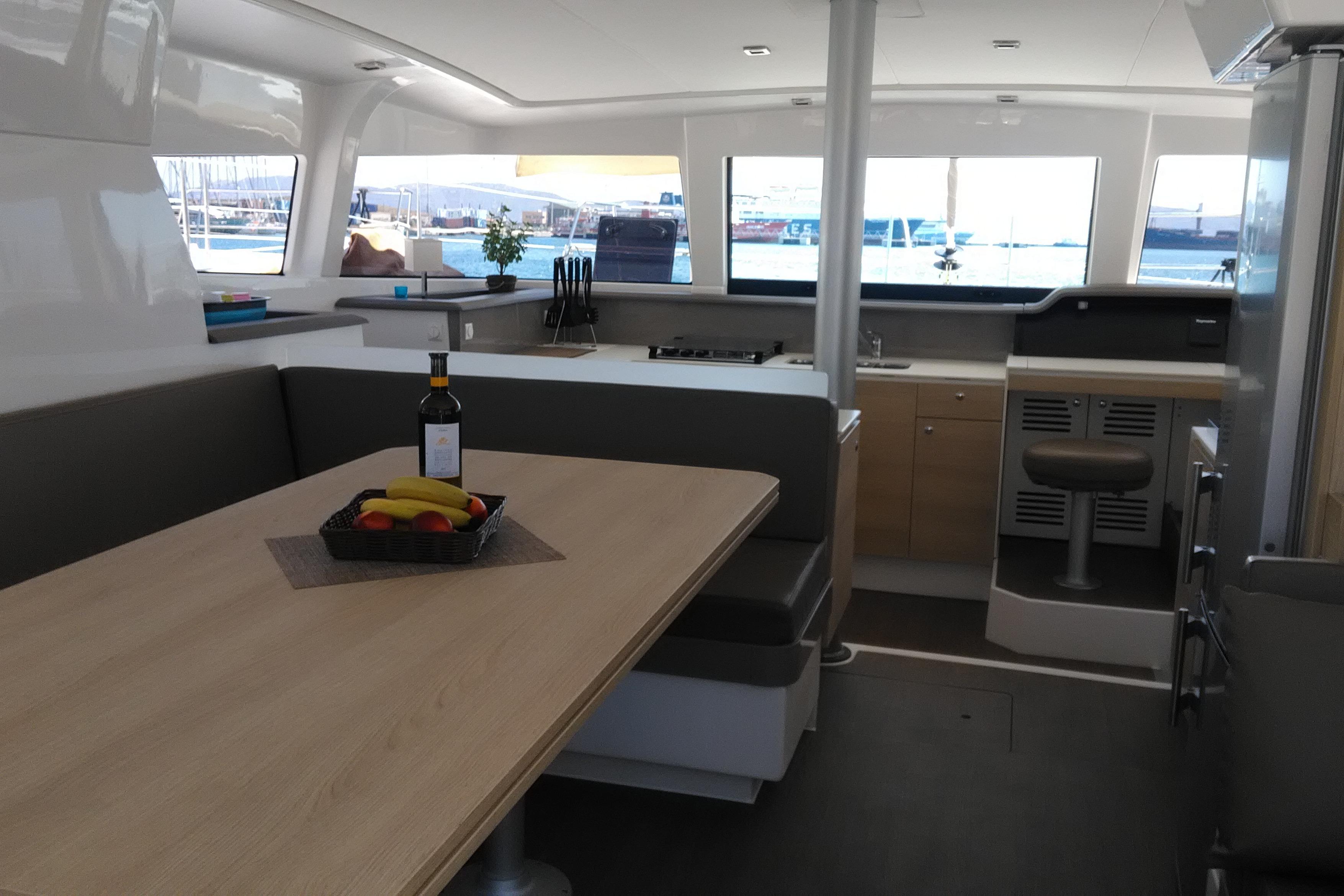 Modern interior of 2018 Bali 4.1 catamaran with dining area and kitchen.