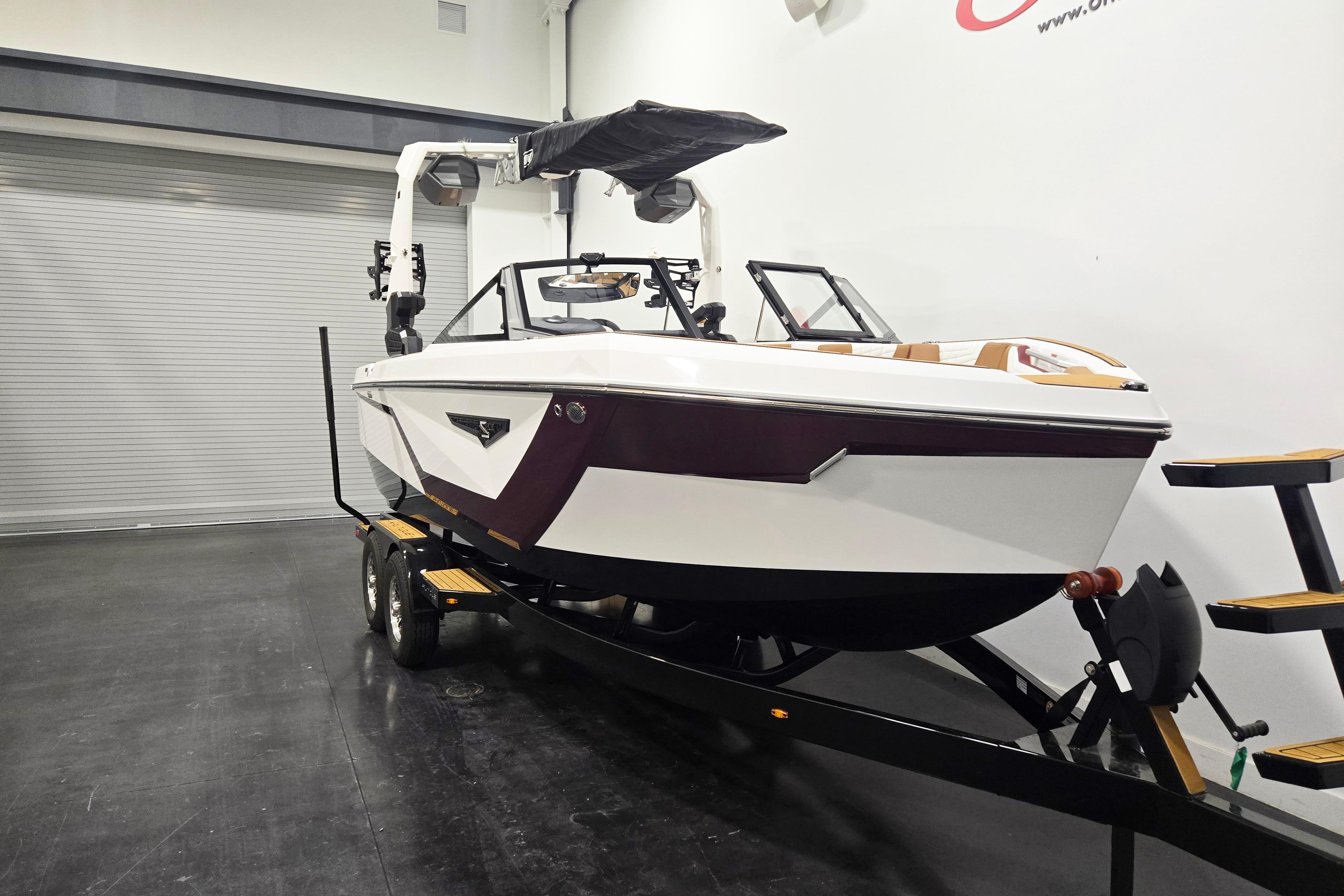 2026 Nautique Super Air Nautique S23 boat on trailer in showroom.