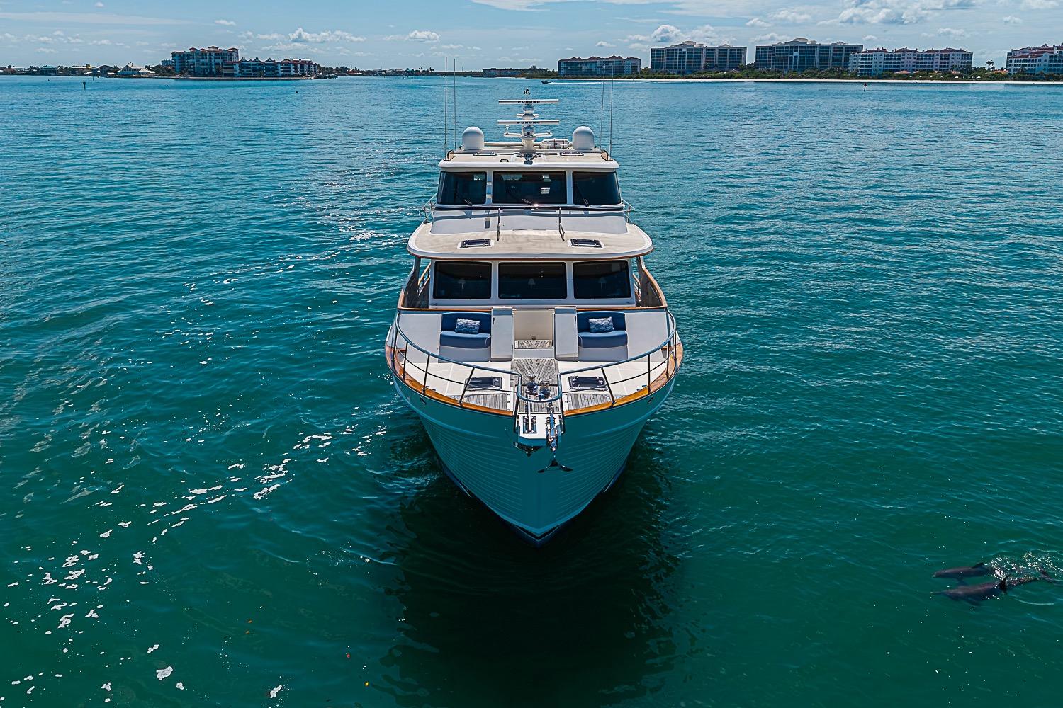 2014 Marlow 80 Explorer yacht on calm blue waters, distant shoreline visible.