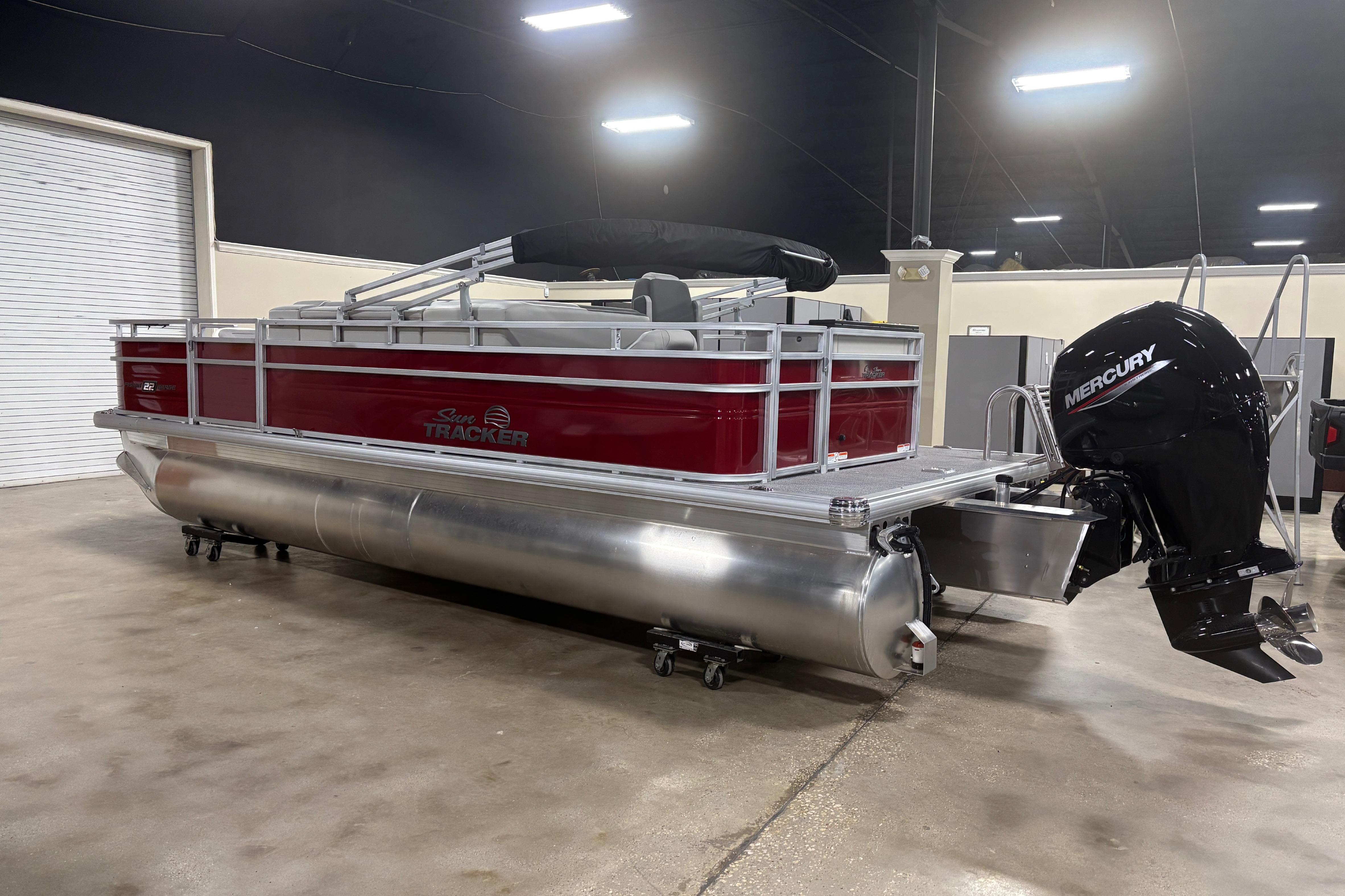 2026 Sun Tracker Fishin' Barge 22 DLX pontoon boat with Mercury outboard motor.