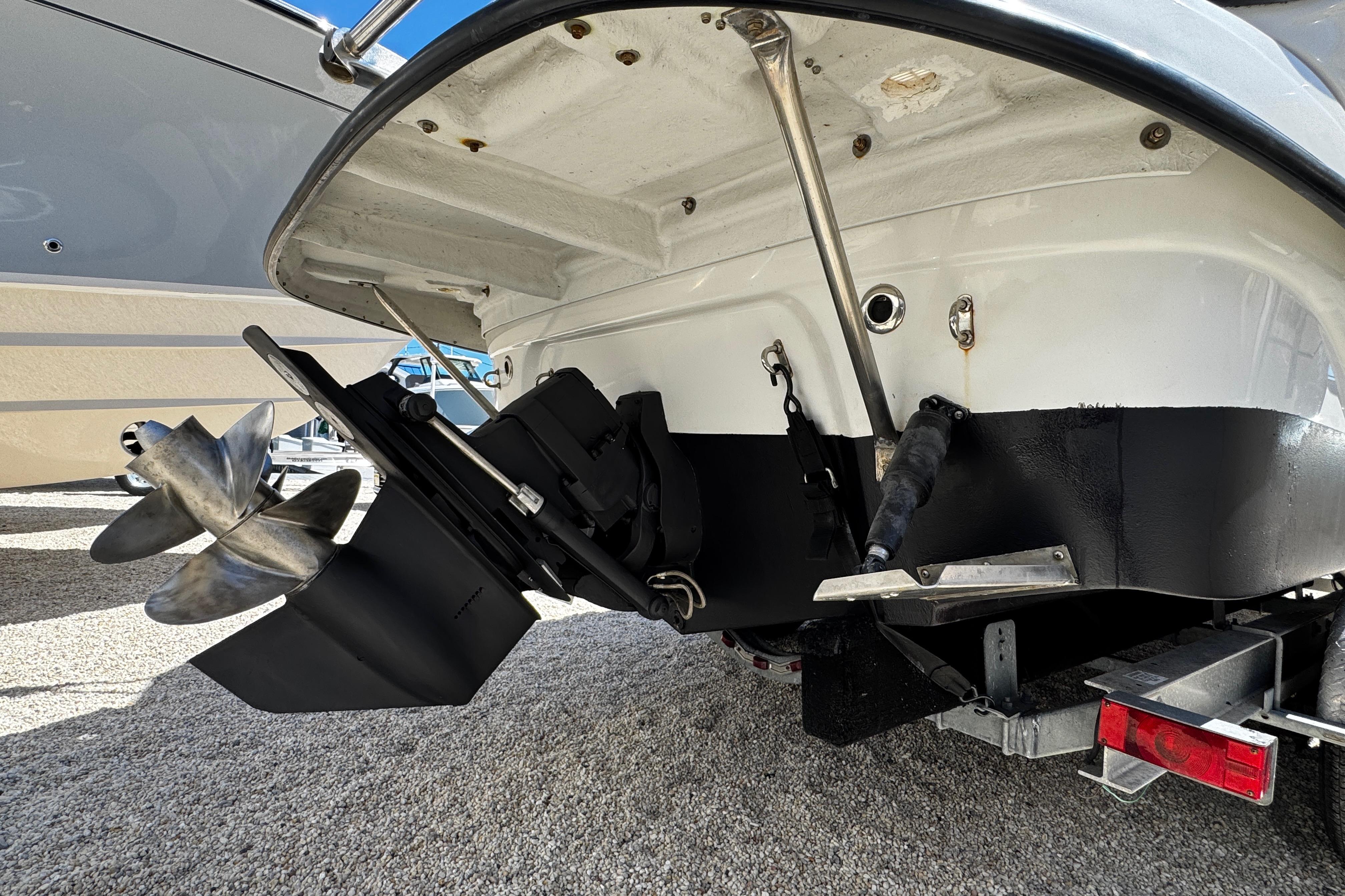 Rear view of a 2004 Crownline 250 CR boat showing propeller and stern details.