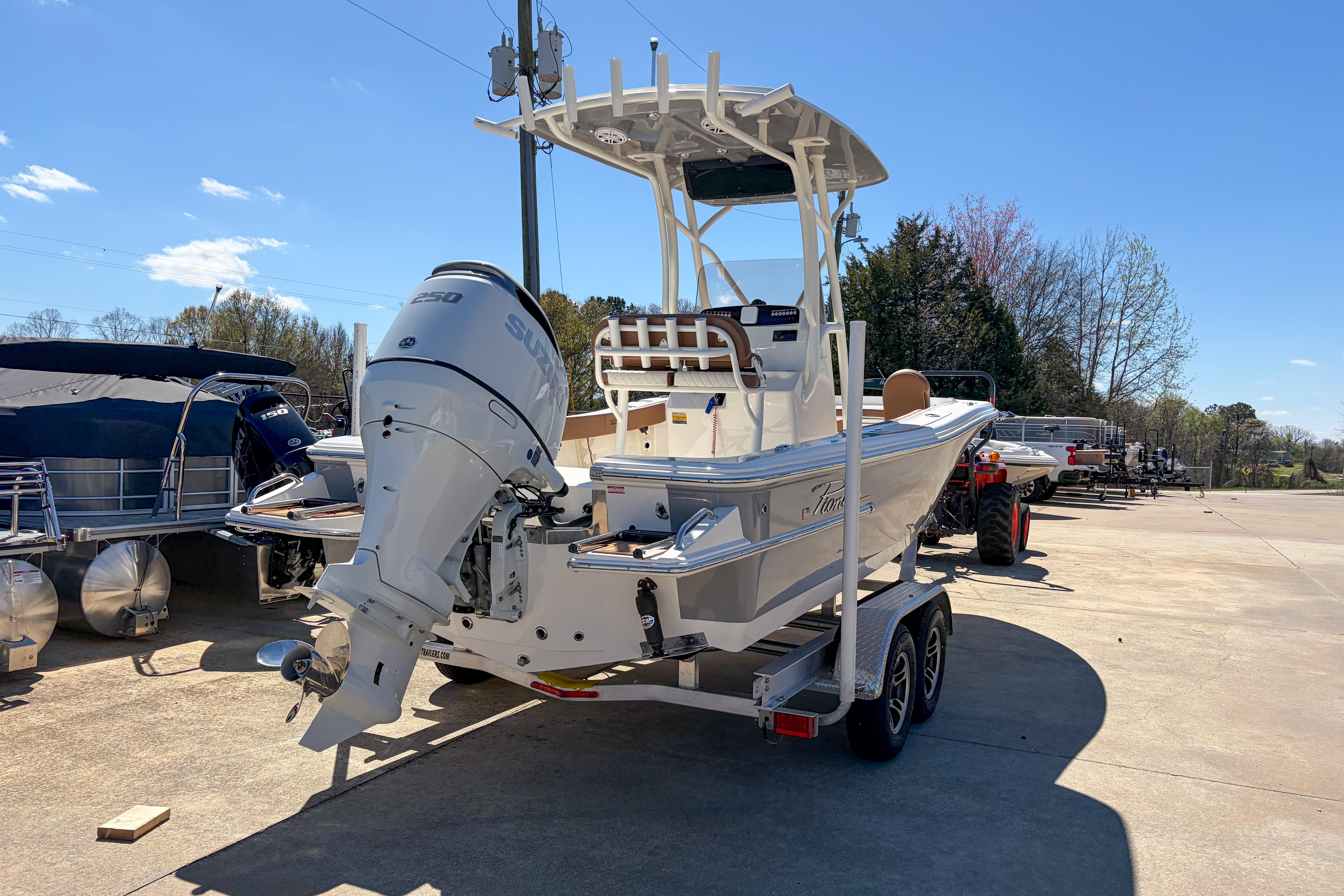 2026 Pioneer 220 Bay Sport boat on trailer with Suzuki outboard motor.