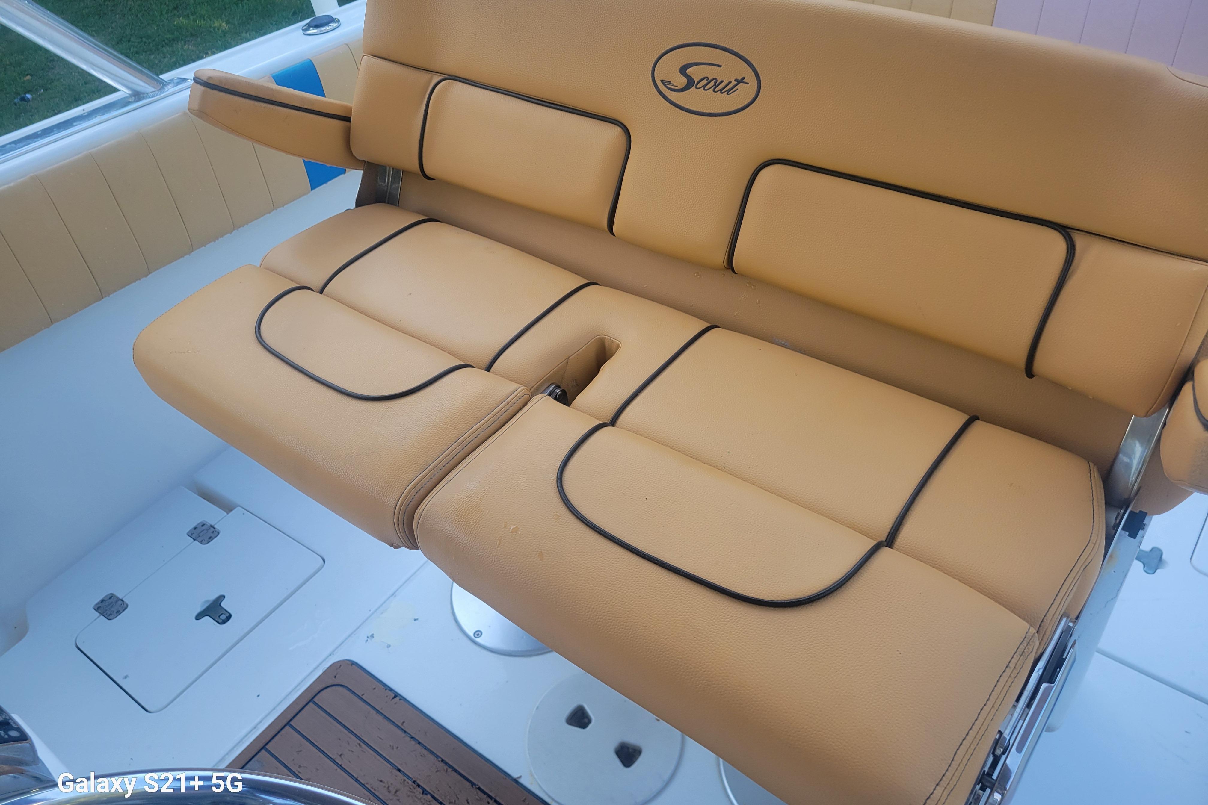 Tan leather seating on a 2005 Intrepid 323 Cuddy boat, featuring black trim accents.