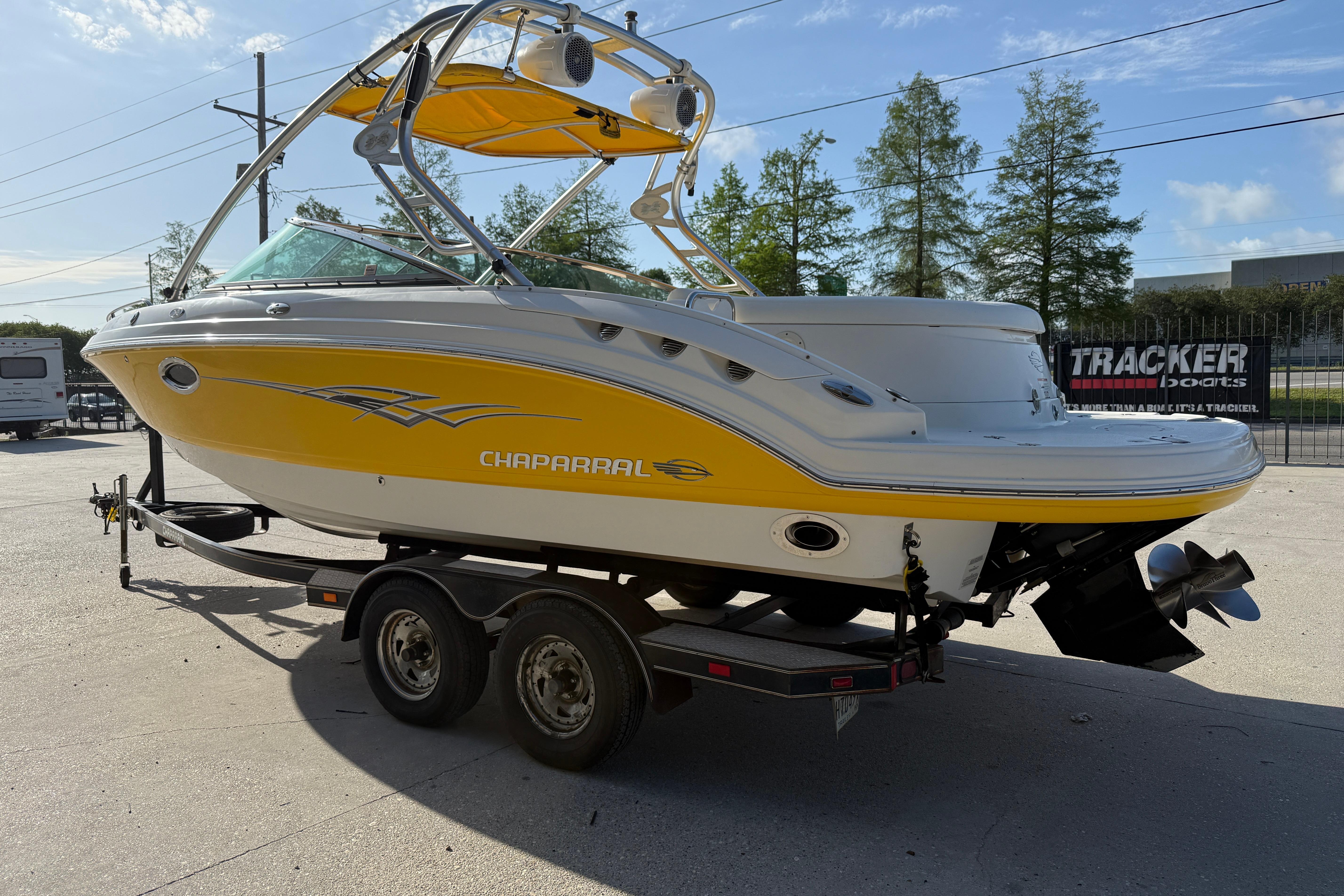2008 Chaparral 236 SSX boat with yellow and white exterior on a trailer.