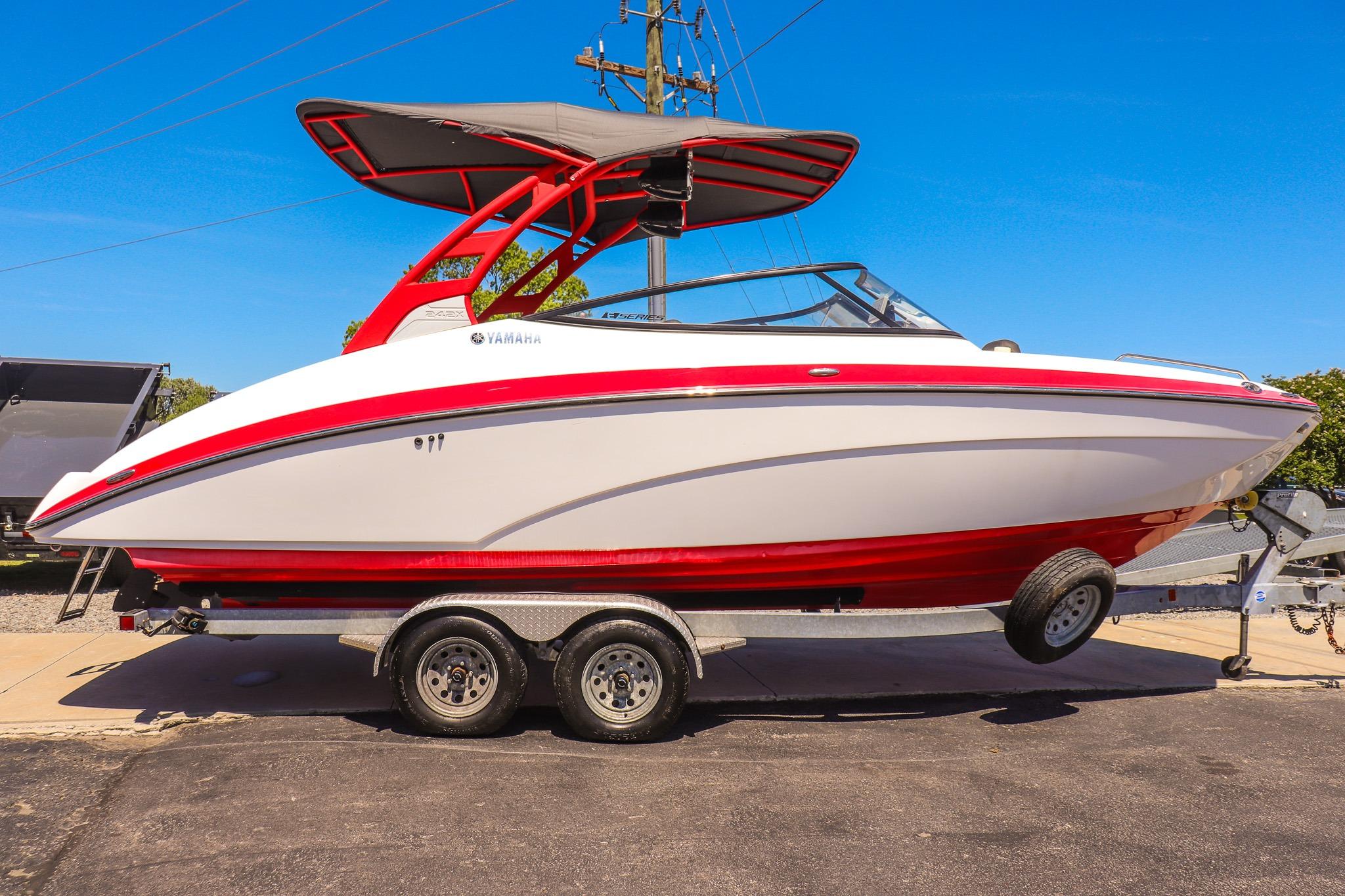2020 Yamaha Boats 242X on trailer, red and white design, sunny day.