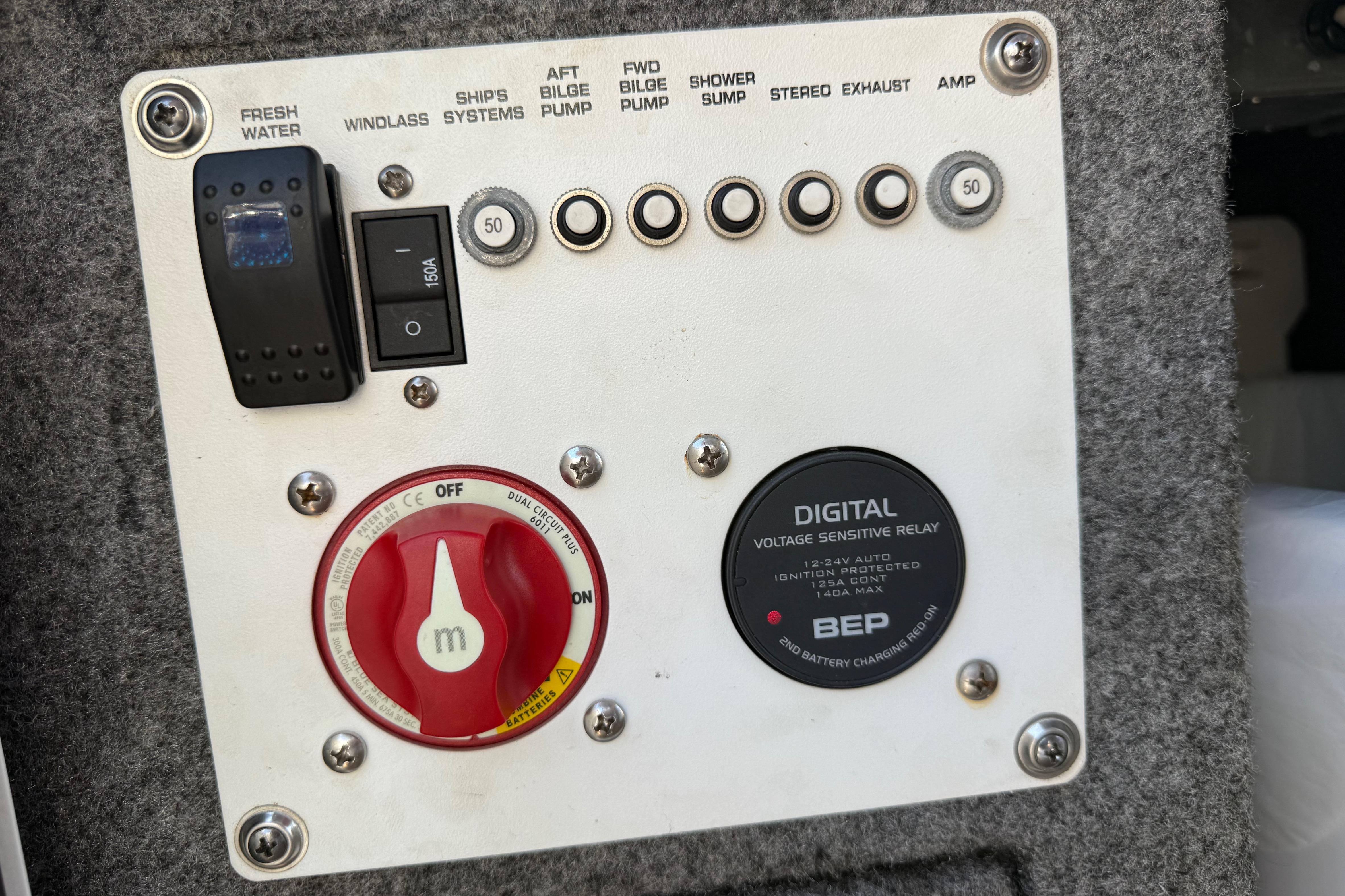 Control panel of a 2017 Four Winns V275 boat with switches and digital relay.