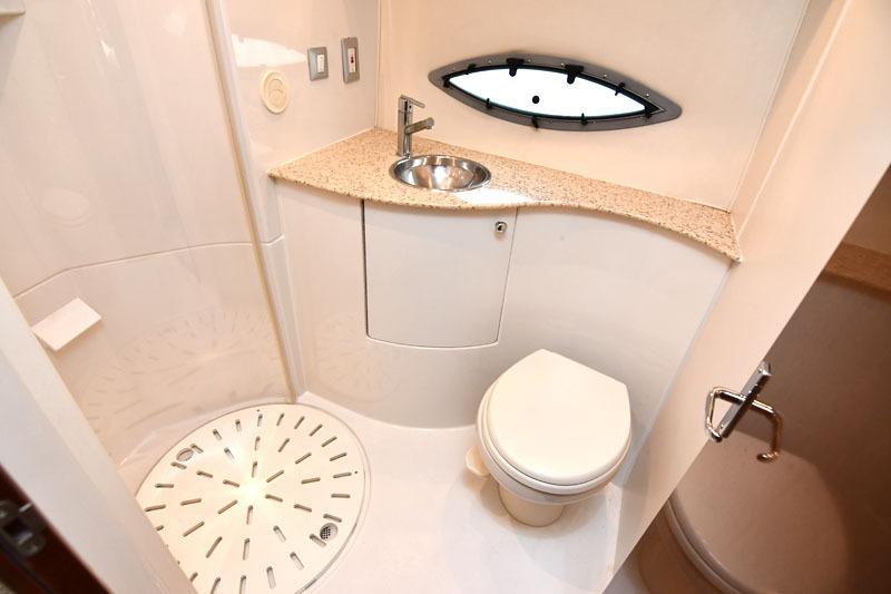 Bathroom interior of 2008 Carver 43 Super Sport yacht with sink, toilet, and shower.