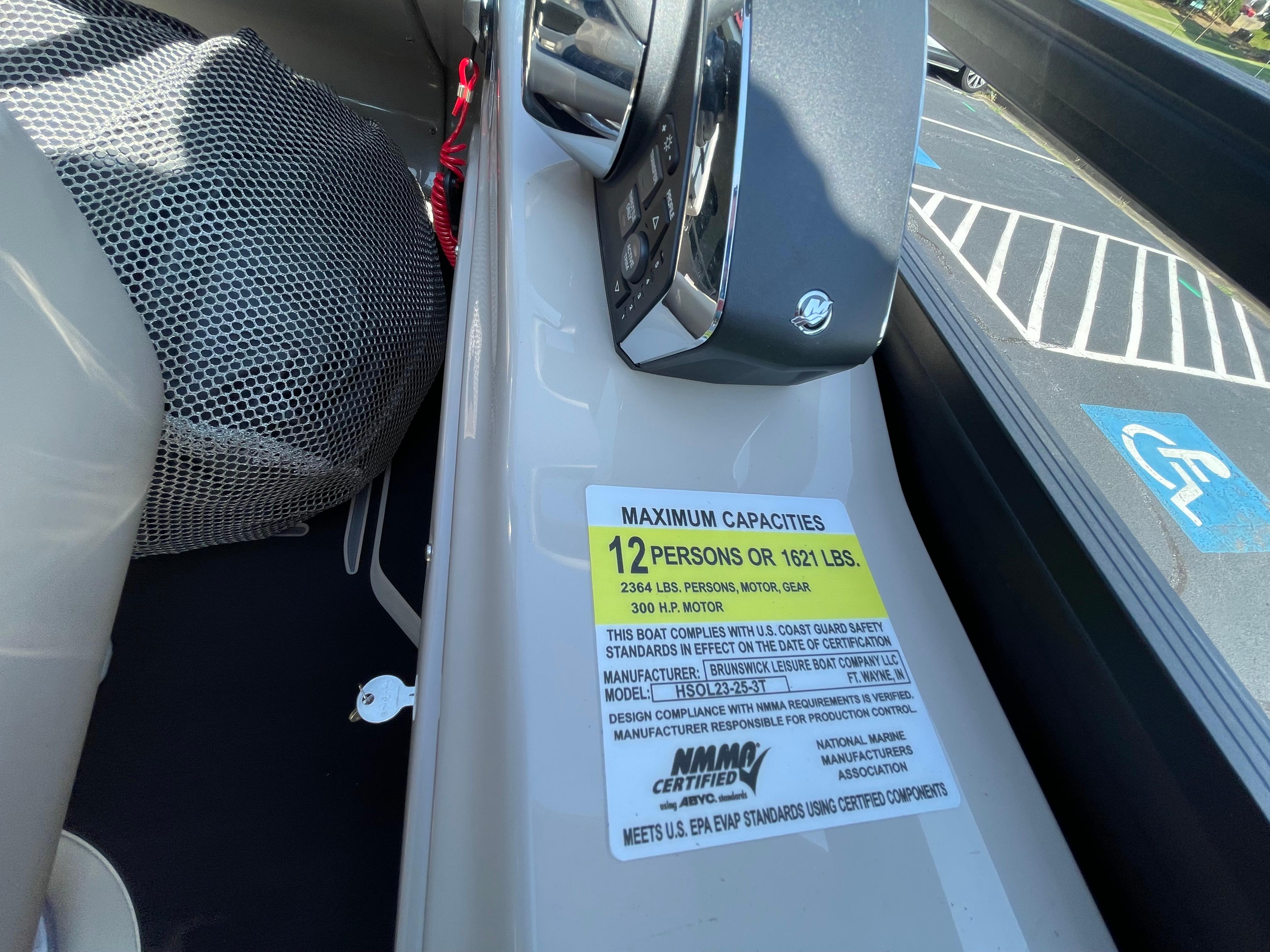 2026 Harris Solstice 230 boat capacity label, seating for 12, 1621 lbs limit.