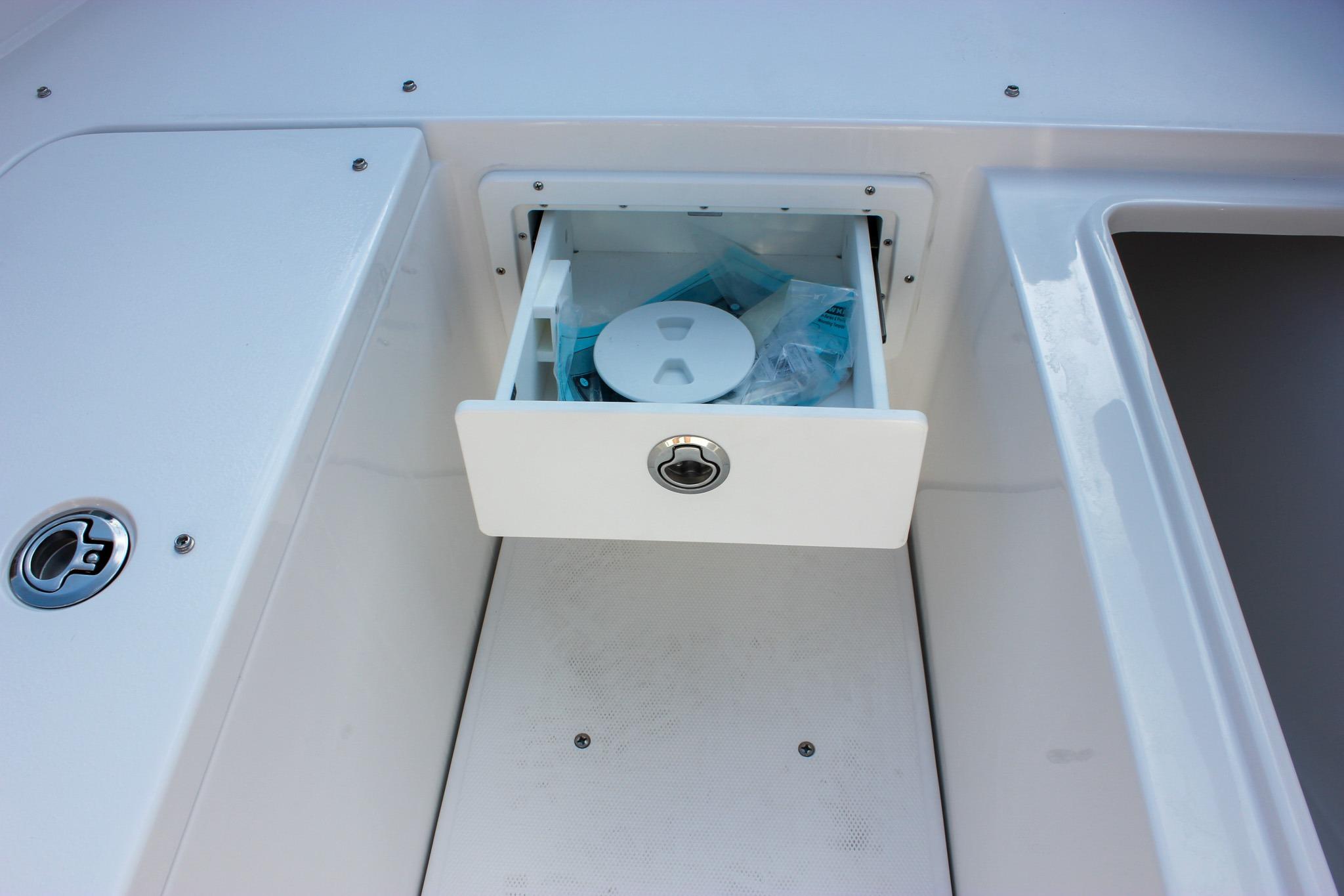 Open storage compartment on 2027 Sea Hunt Ultra 275 SE boat deck.