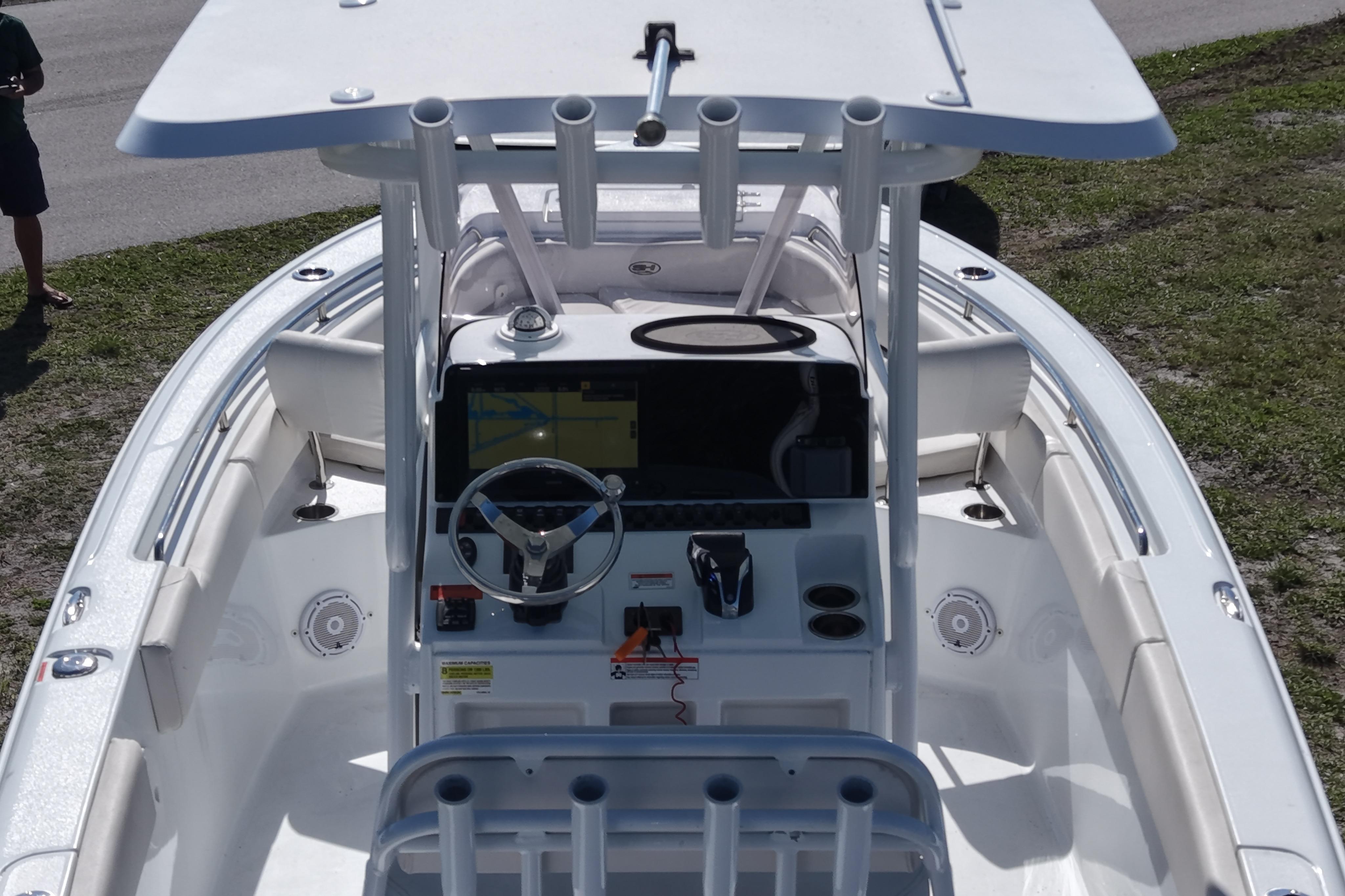 2021 Sea Hunt Ultra 234 boat cockpit with steering wheel and navigation system.