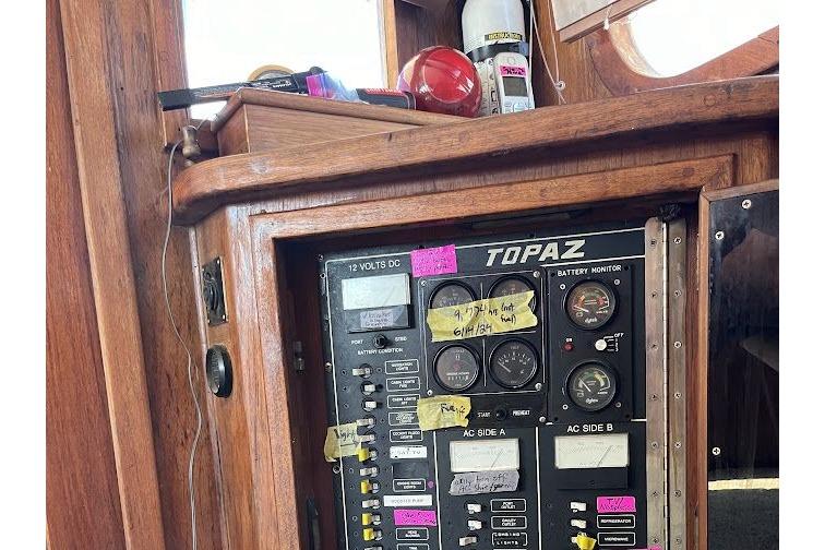 Control panel of a 1989 Topaz 44 Sportfisherman boat with gauges and labels.