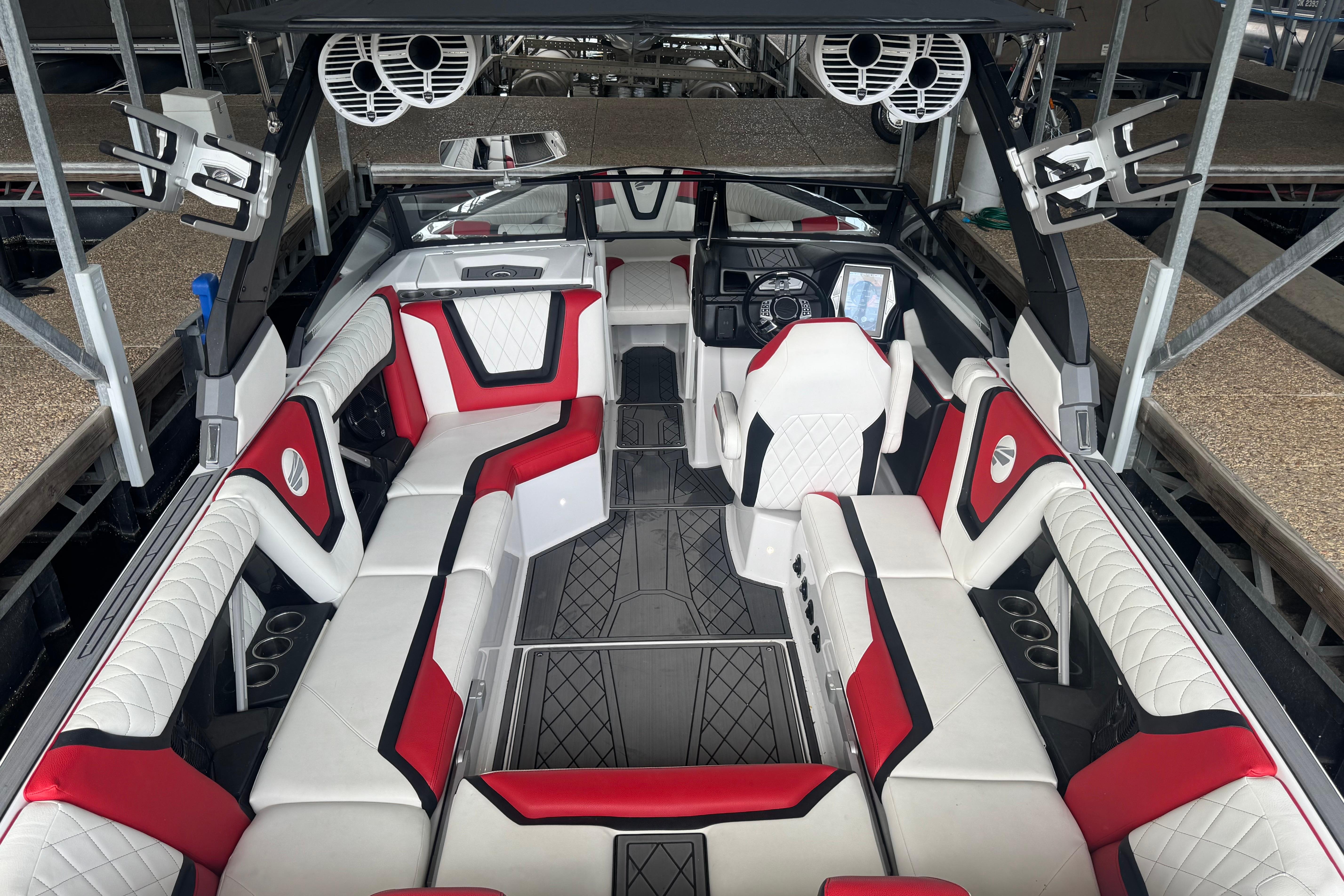 2020 Tige 25ZX boat interior with red and white seating, advanced dashboard, and speakers.