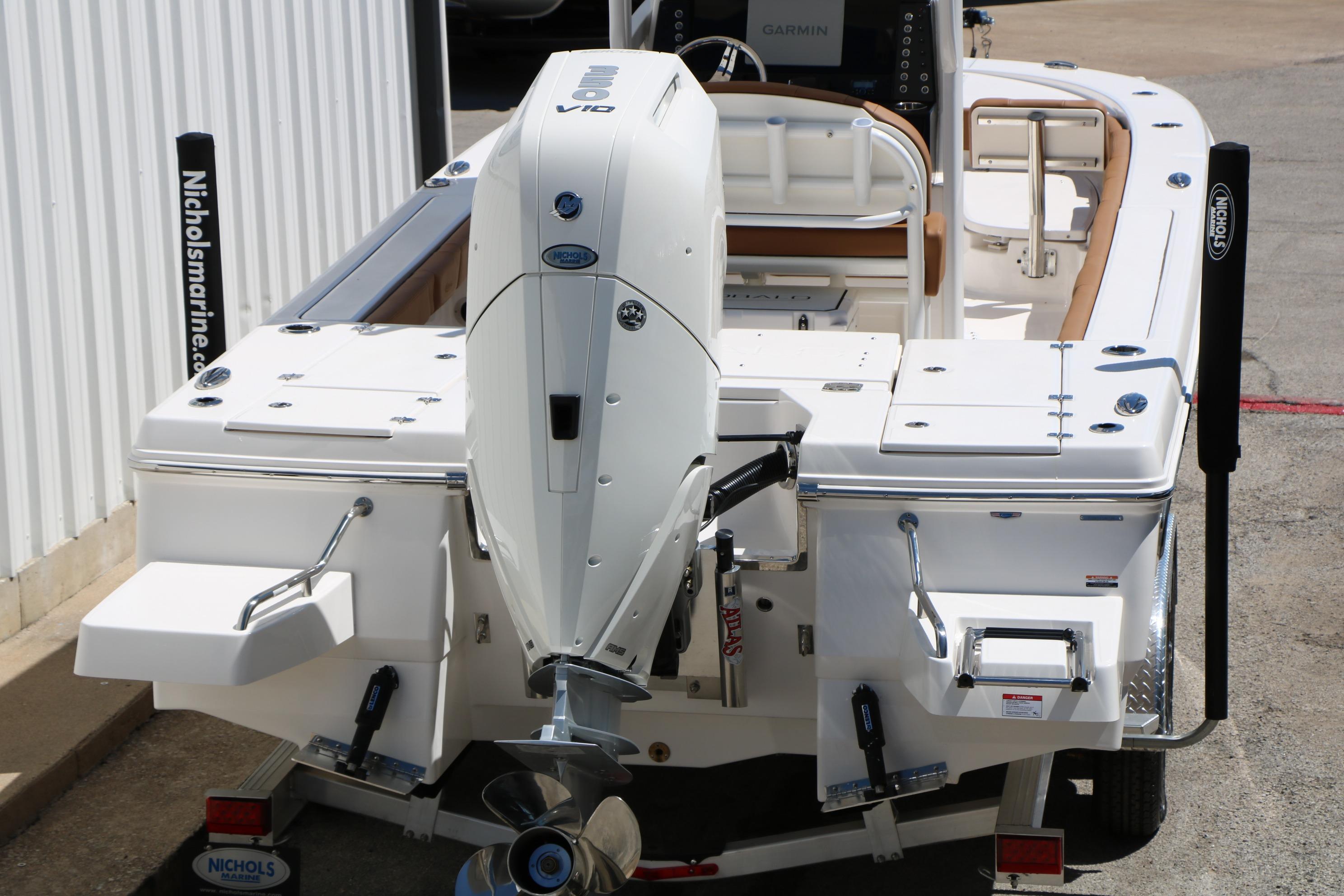 2026 Robalo 246 Cayman boat with powerful outboard motor, docked at marina.