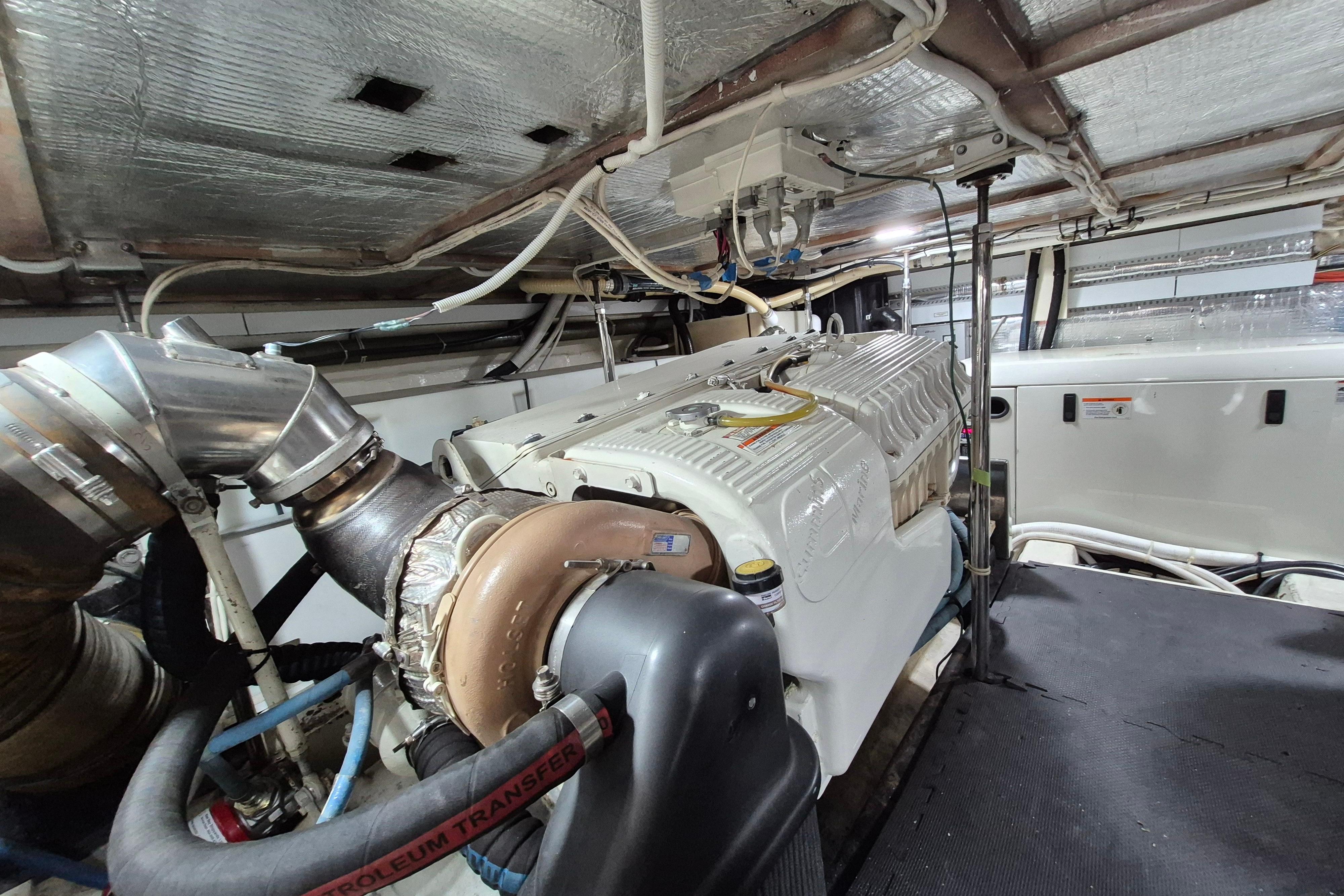 Engine room of 2005 Carver 560 Voyager yacht, showcasing detailed mechanical components.