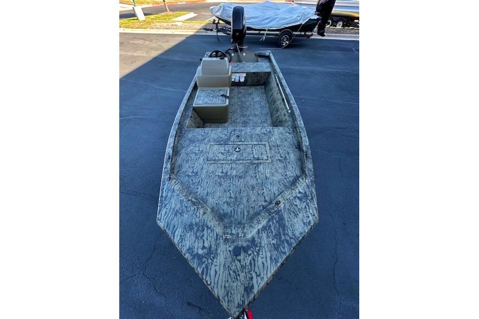 2026 Tracker Grizzly 1648 SC boat with camouflage design on pavement.