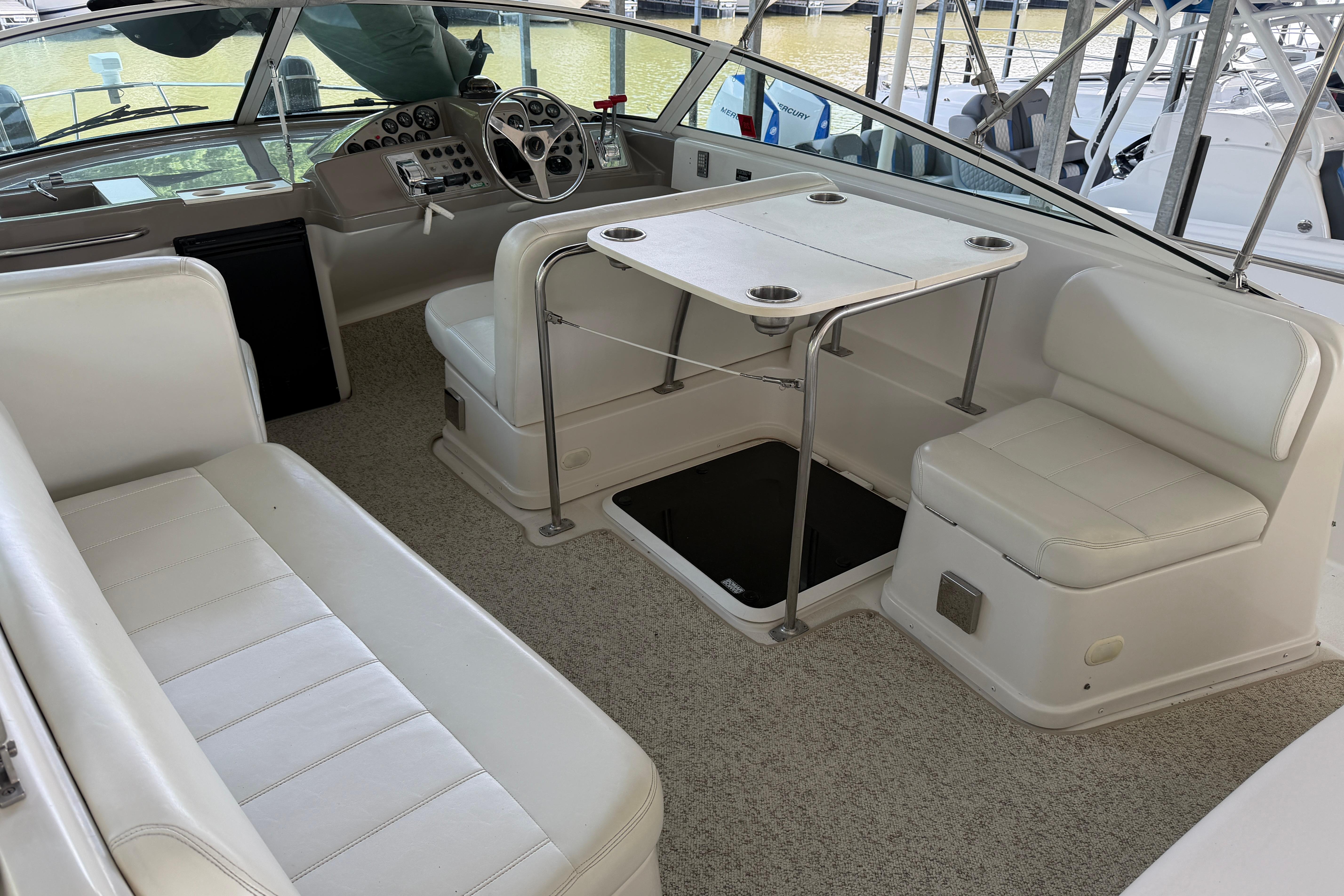 Interior of 2000 Carver 350 Mariner yacht with white seating and helm station.