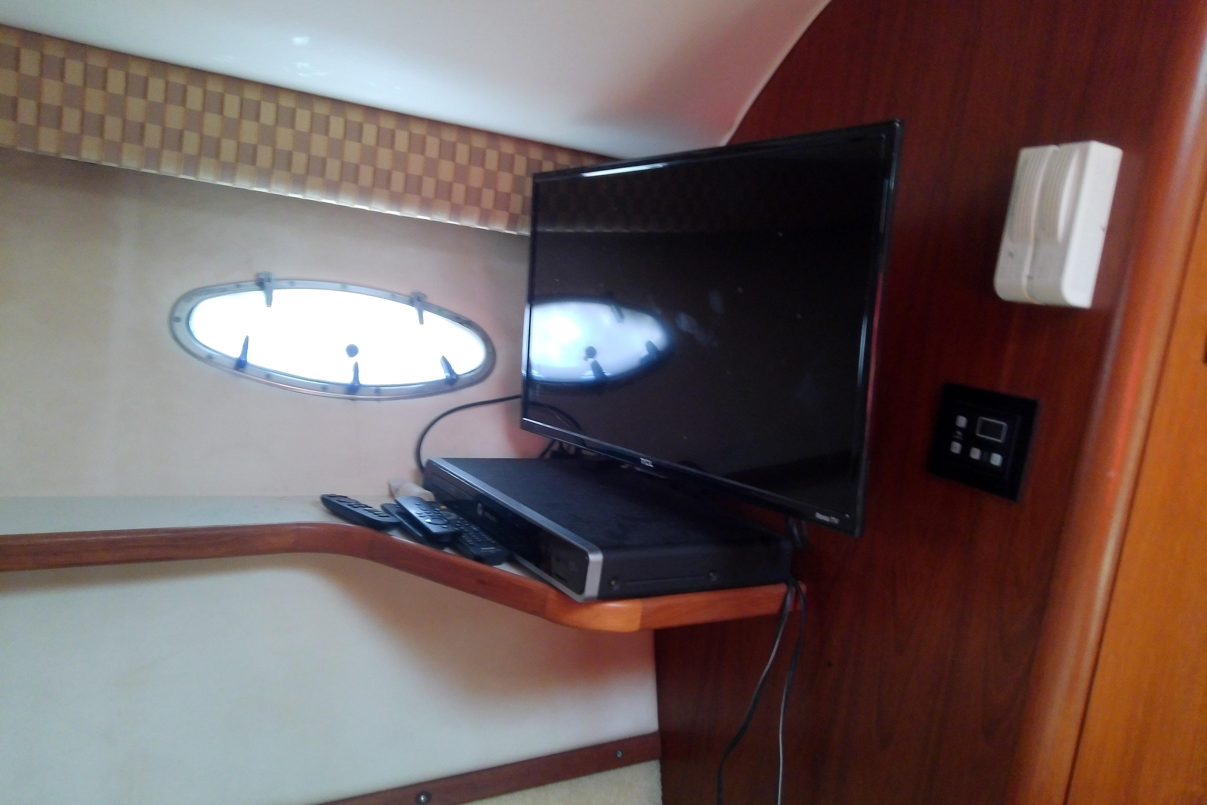 Interior of 2000 Tiara Yachts 4100 Open with TV and porthole window.