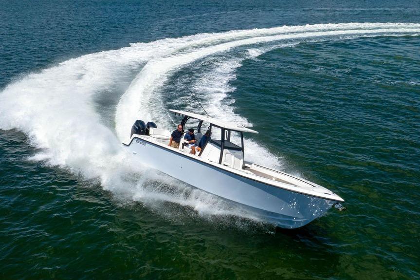 2027 Reef Runner 340 boat making a sharp turn on open water.