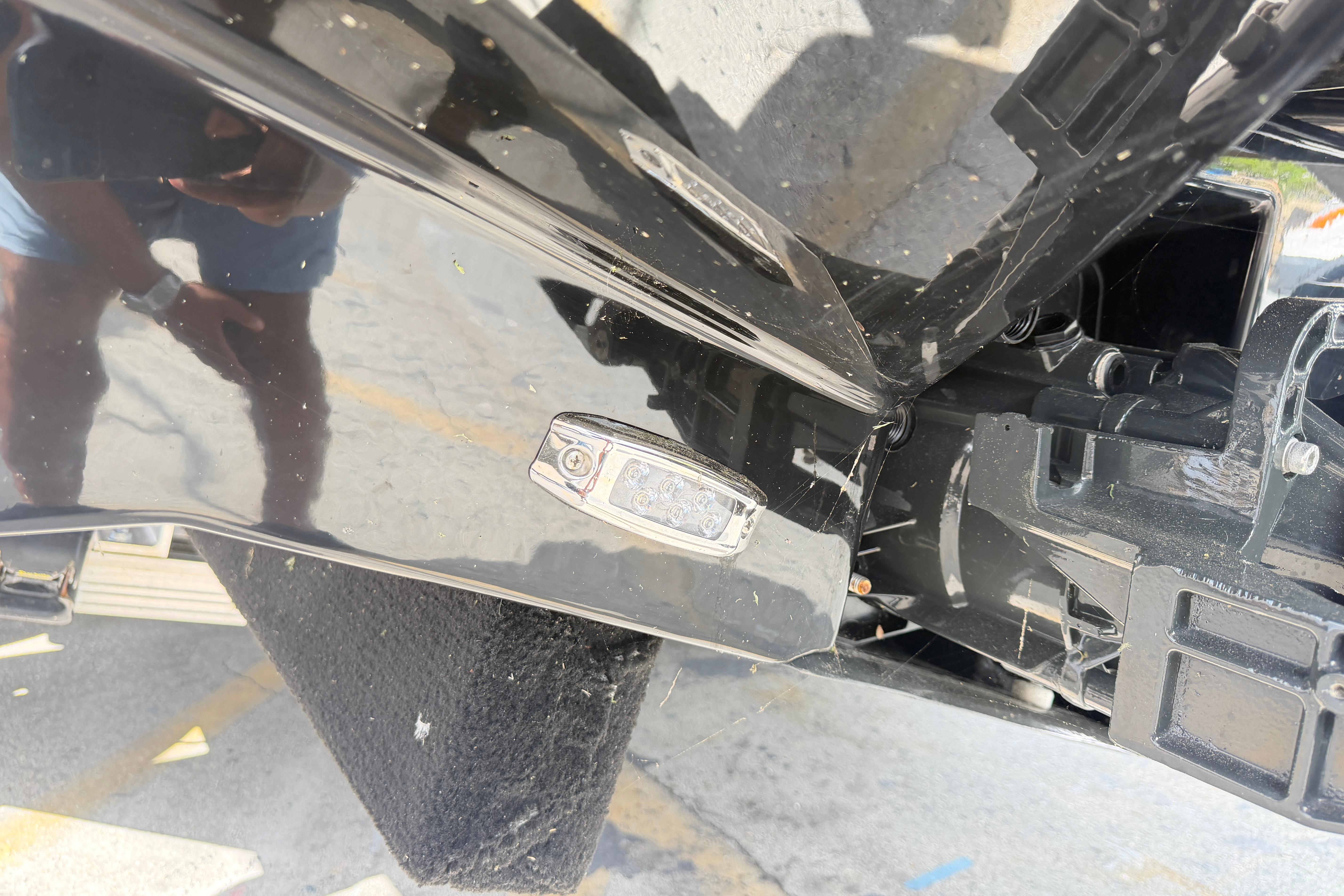 Close-up of a 2026 Scarab 235 LX boat's sleek black exterior and hardware details.