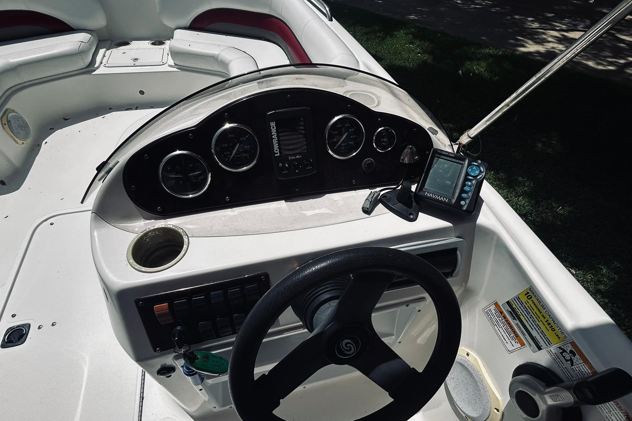 2013 Hurricane SunDeck Sport 201 OB boat dashboard with gauges and navigation equipment.