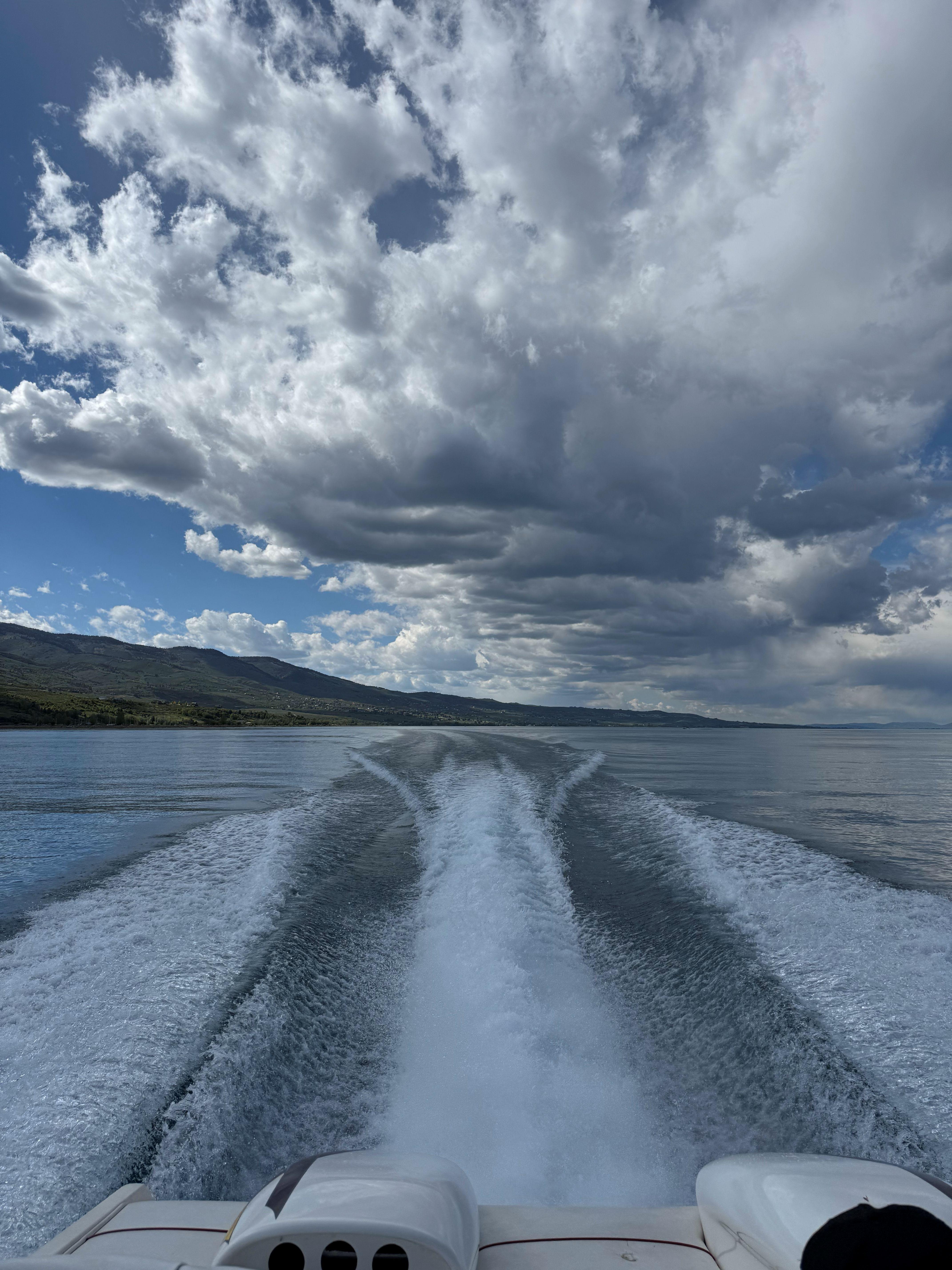 Boat wake on a lake under dramatic clouds, Advantage Victory 2002.