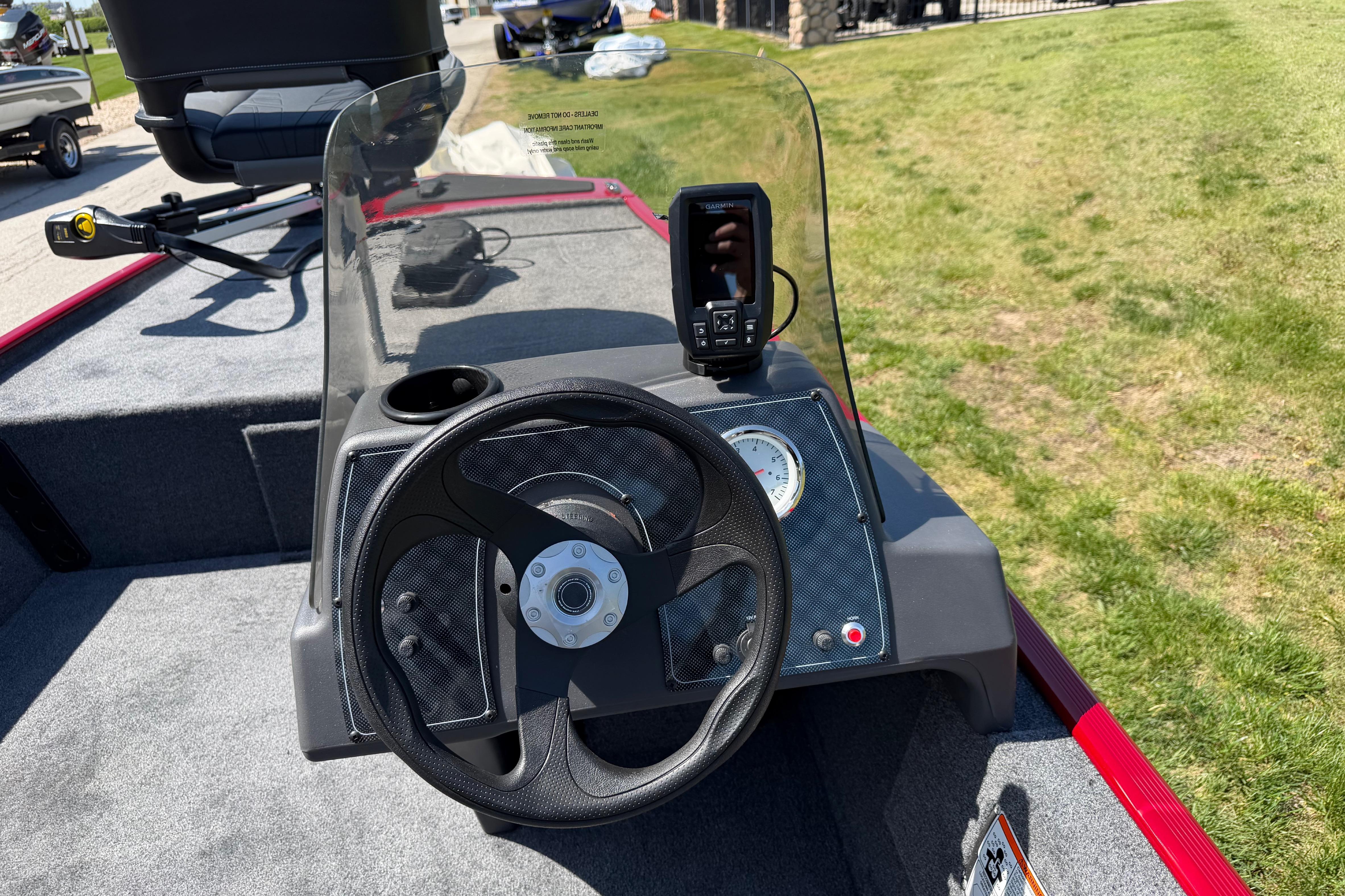 2026 Tracker Bass Tracker Classic XL boat dashboard with steering wheel and fish finder.