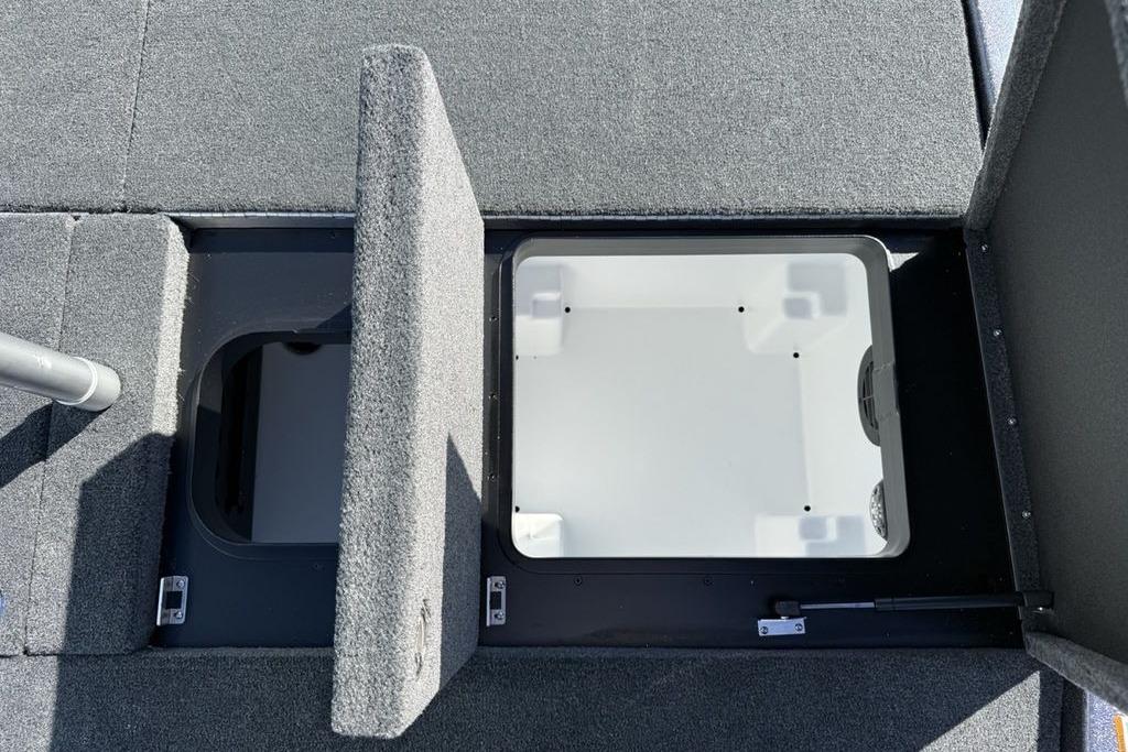 2026 Skeeter ZXE21 boat storage compartments with open lids, showcasing interior space.