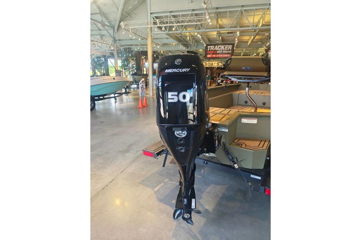 2026 Tracker Grizzly 1650 T Prairie Wings Edition with Mercury 50 outboard motor in showroom.