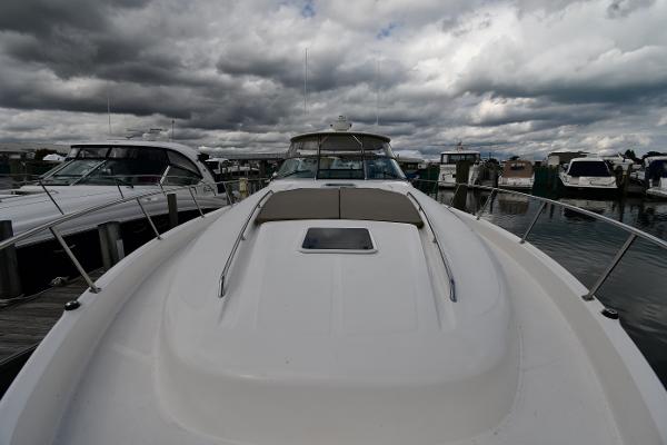 2003 Sea Ray 460 Sundancer yacht docked under cloudy skies.