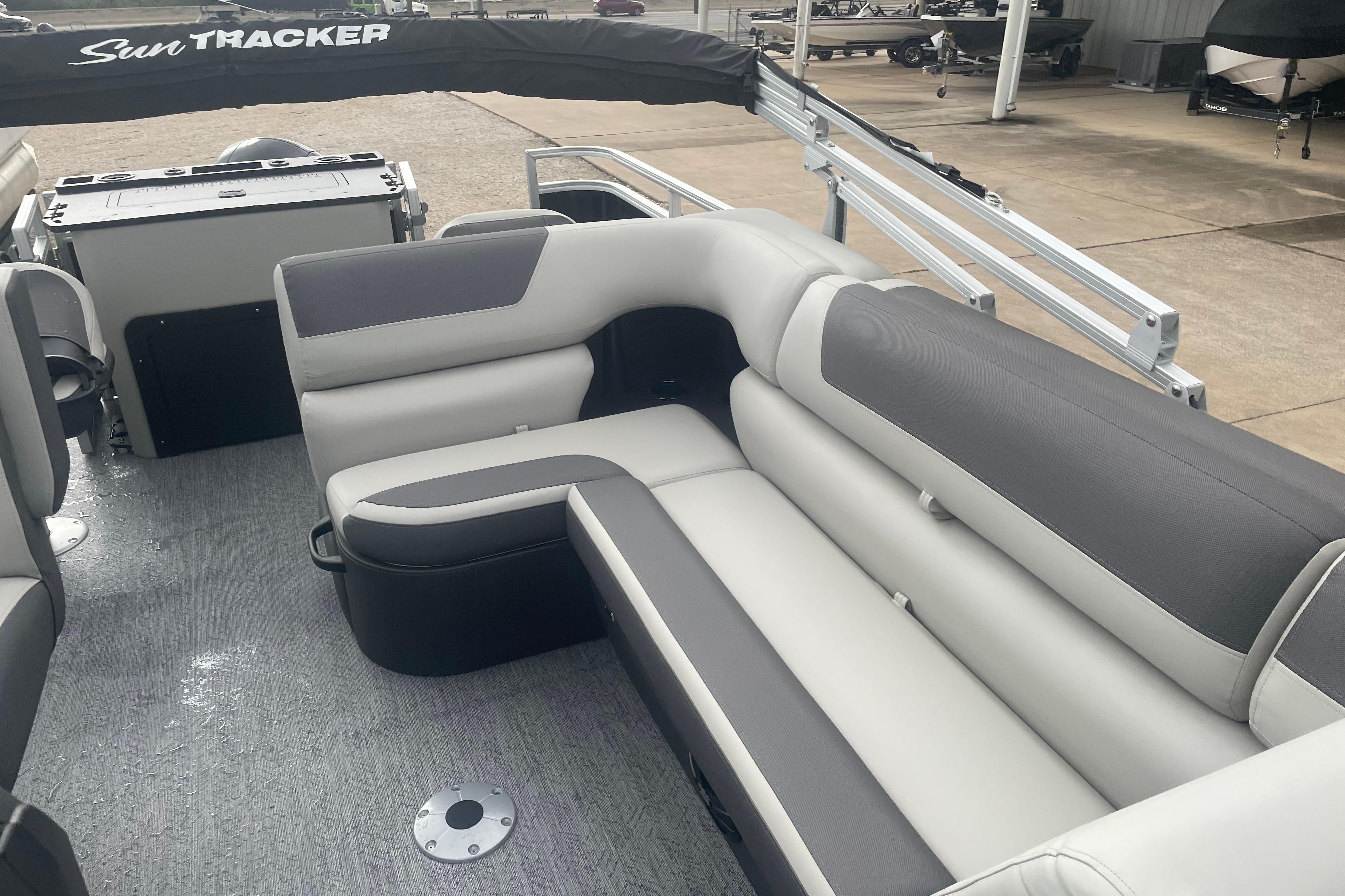 2026 Sun Tracker Fishin' Barge 22 XP3 interior with gray and white seating.