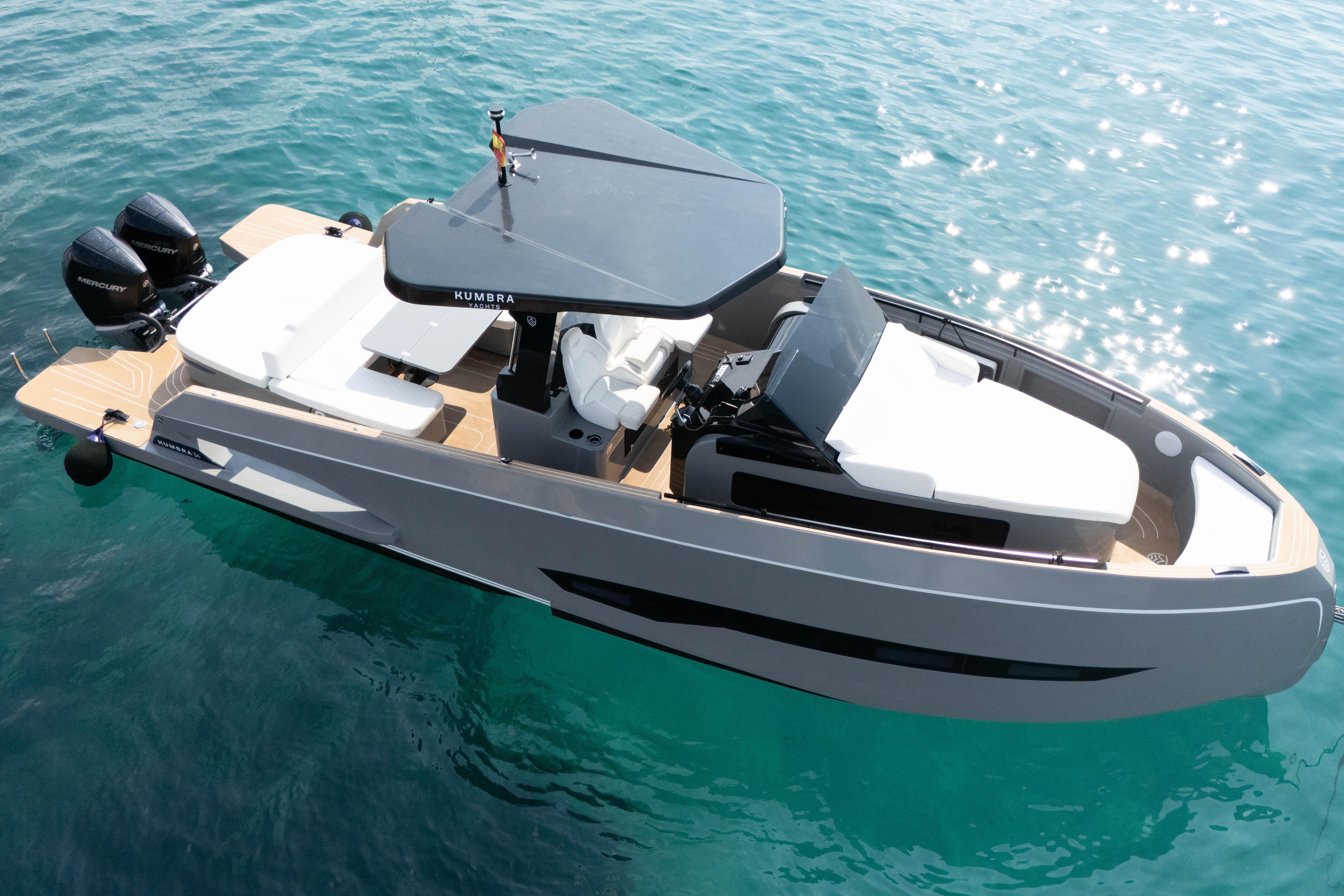 Modern 2025 Kumbra 34 boat on clear blue water, featuring sleek design and dual outboard motors.