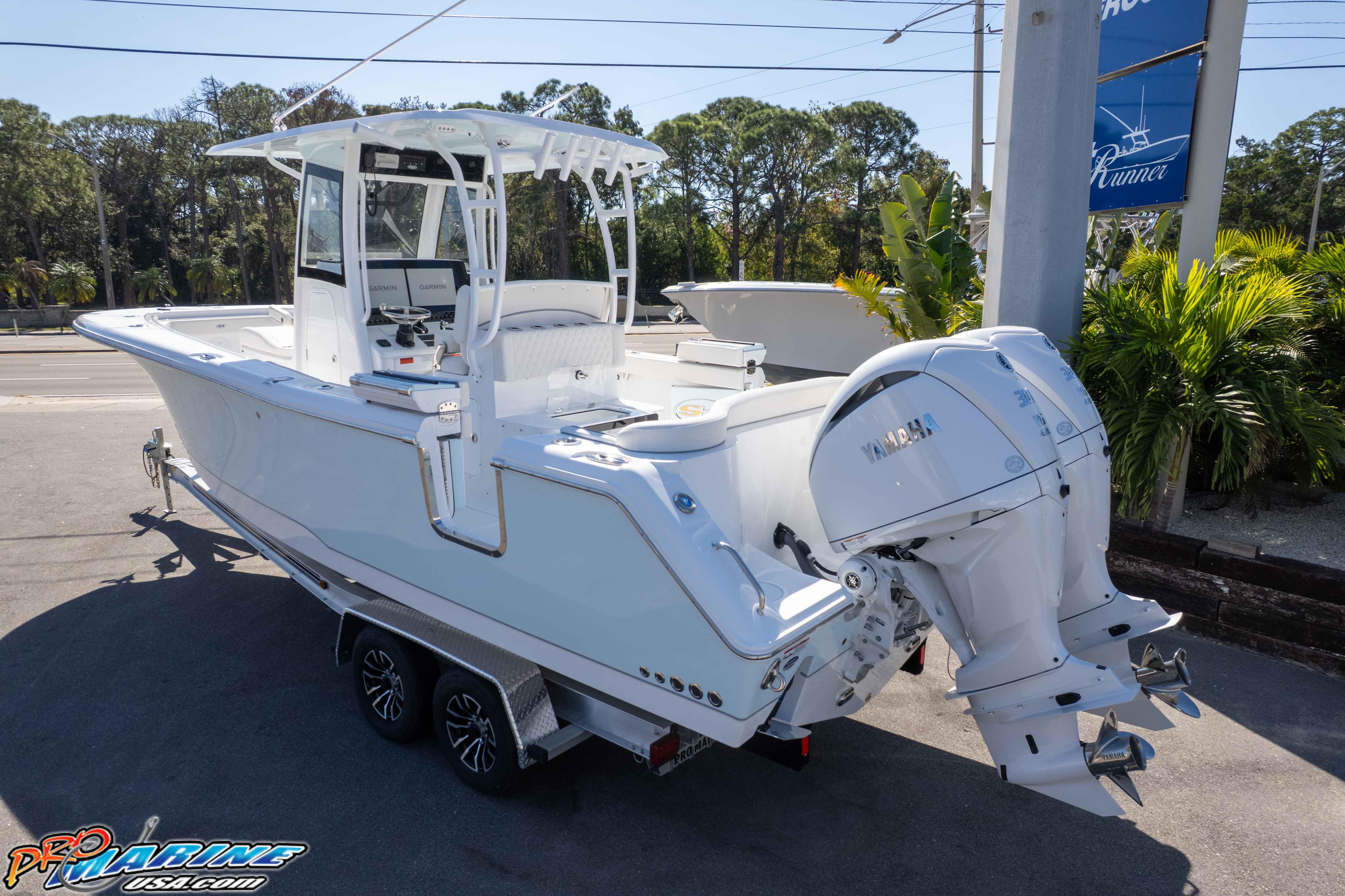 2026 Sea Hunt Ultra 285 SE boat with dual Yamaha engines on a trailer.