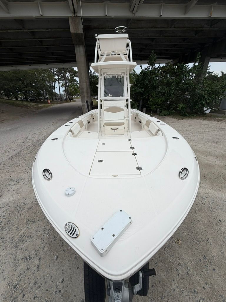 2018 Robalo 246 Cayman SD boat parked under bridge.