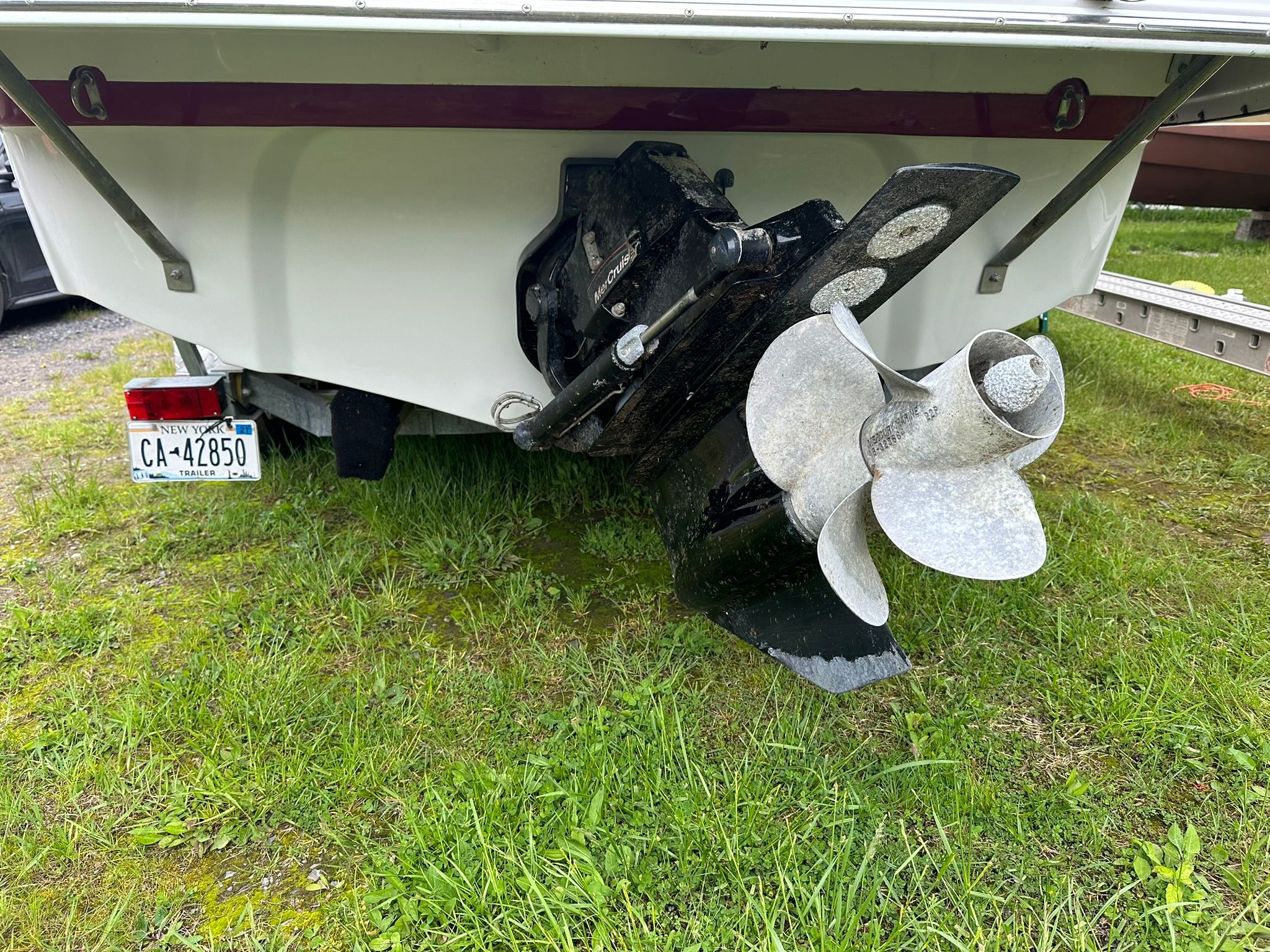 Rear view of a 2009 Crownline 220 EX with a large propeller on grass.