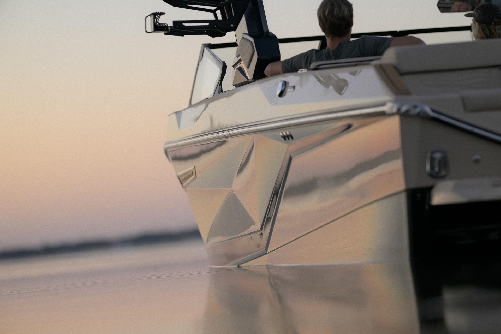 2026 Nautique Super Air Nautique G23 boat on calm water at sunset.