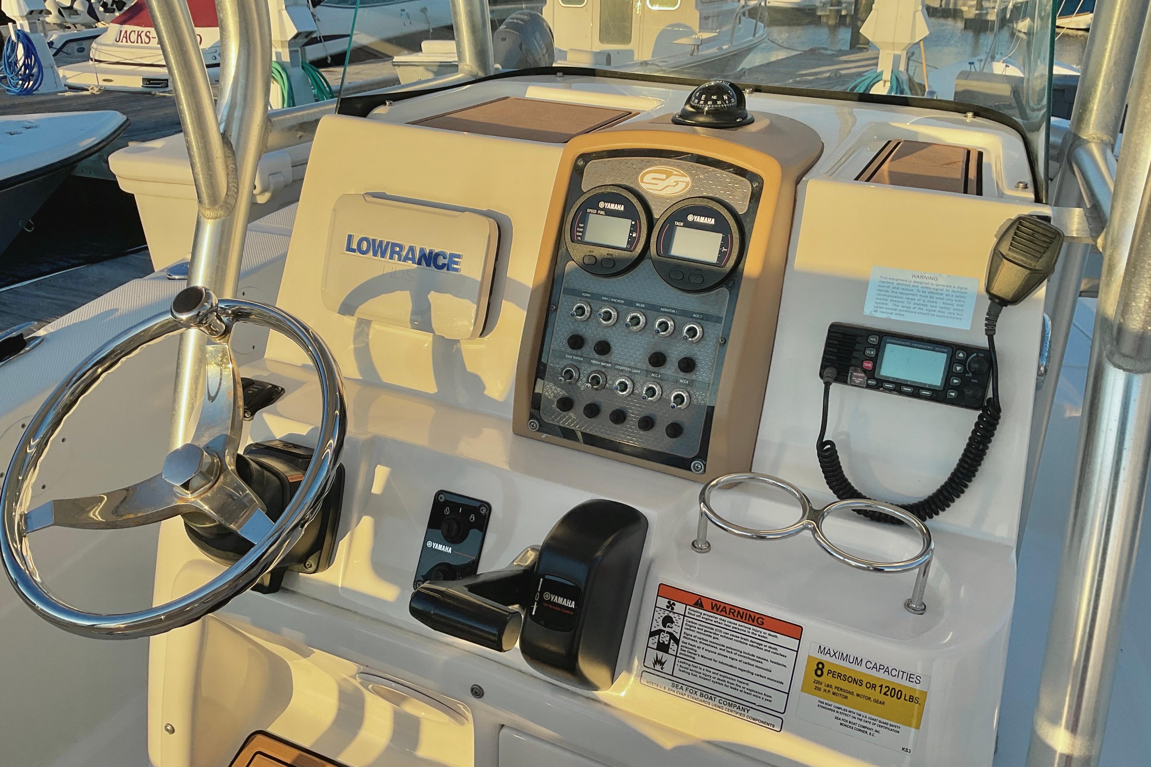2016 Sea Fox 226 Commander boat dashboard with steering wheel and navigation equipment.