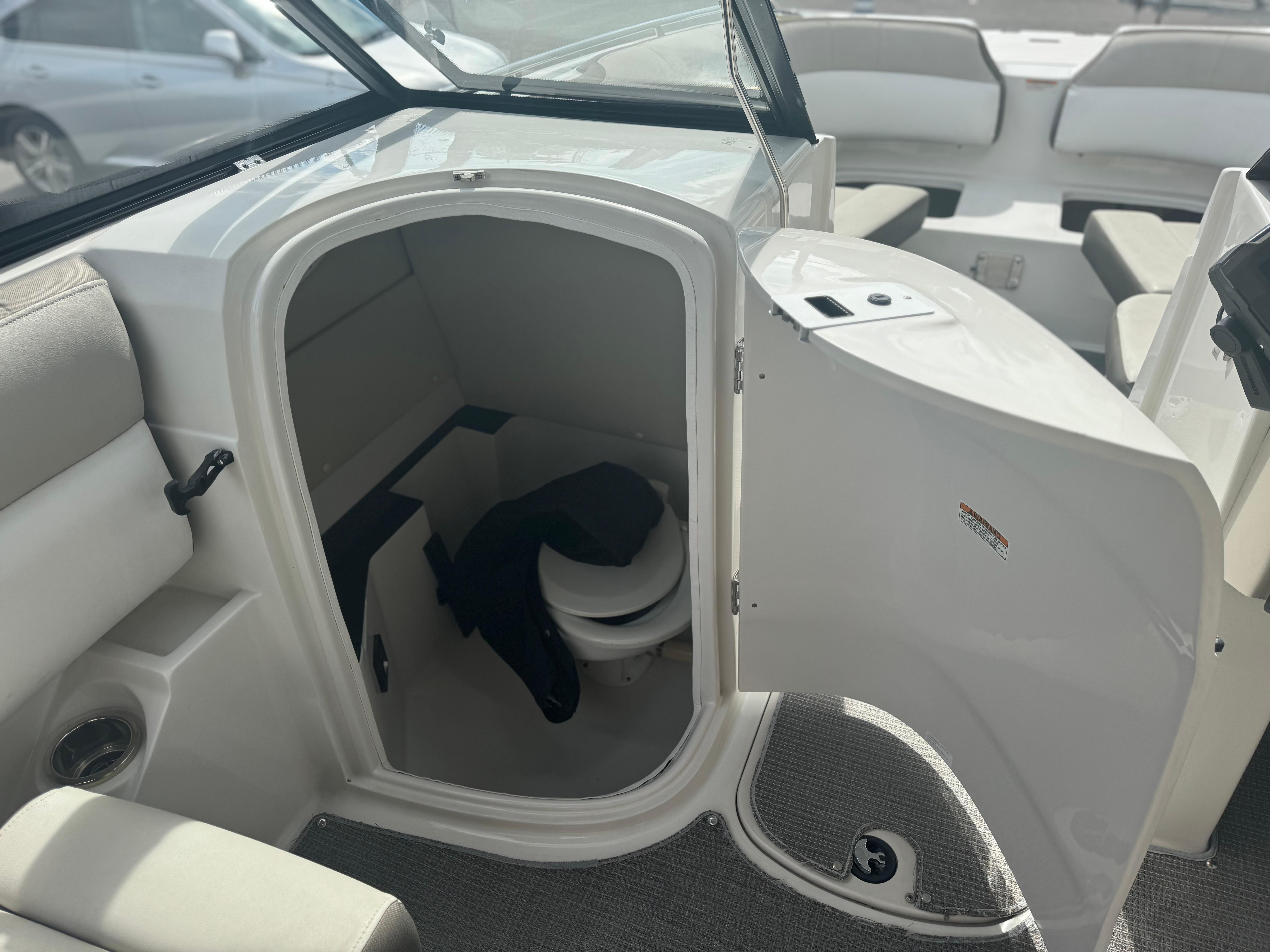 2017 Starcraft 230 OB SCX EXT boat interior with open cabin door and seating.