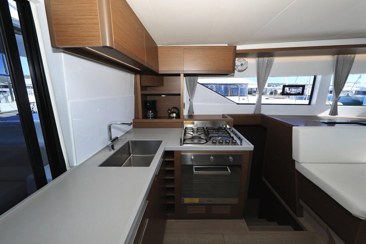 Modern kitchen in 2021 Lagoon 50 catamaran with stove, oven, and sink.