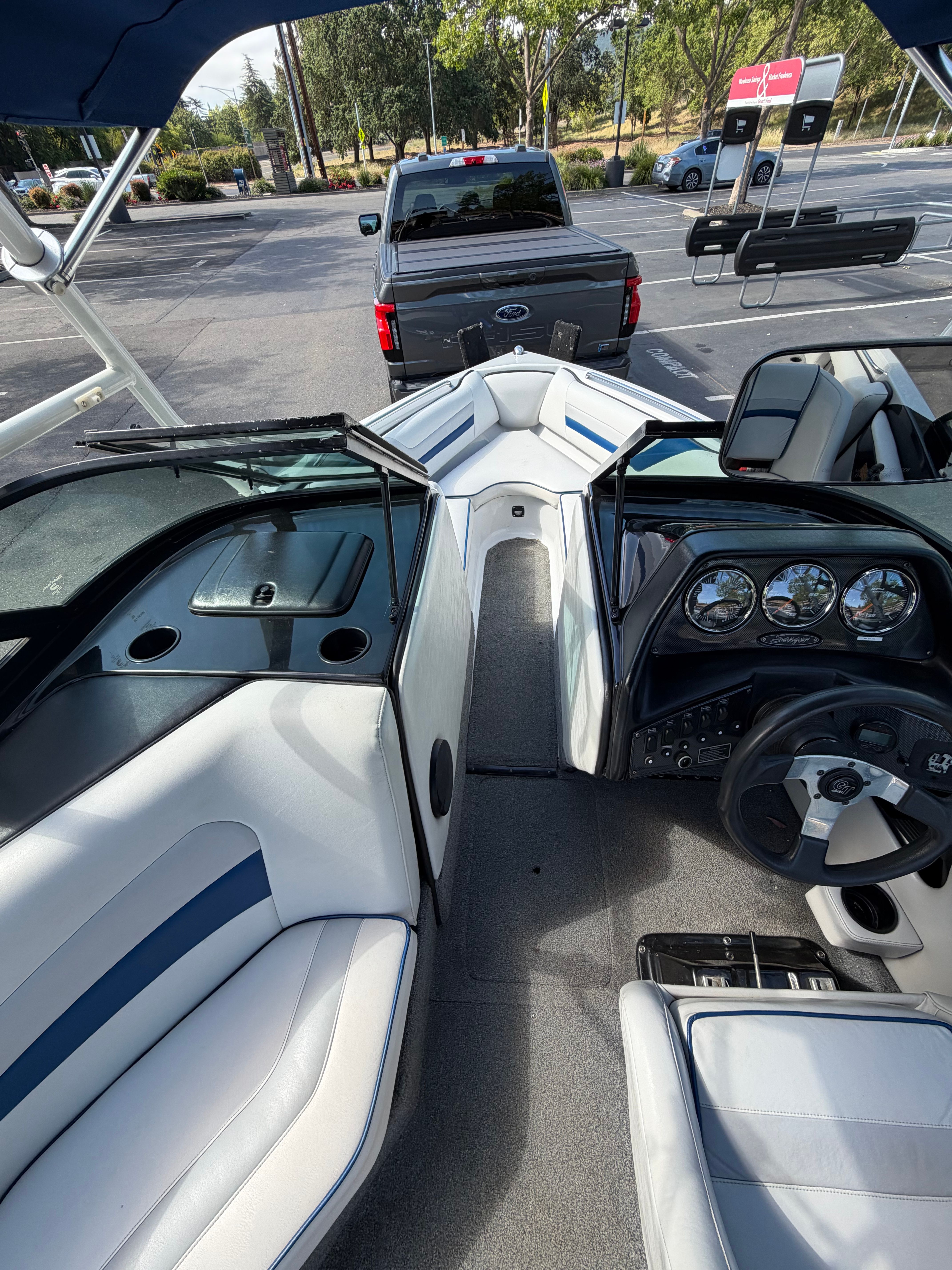 Interior view of a 2001 Sanger V210 boat with white and blue seating.