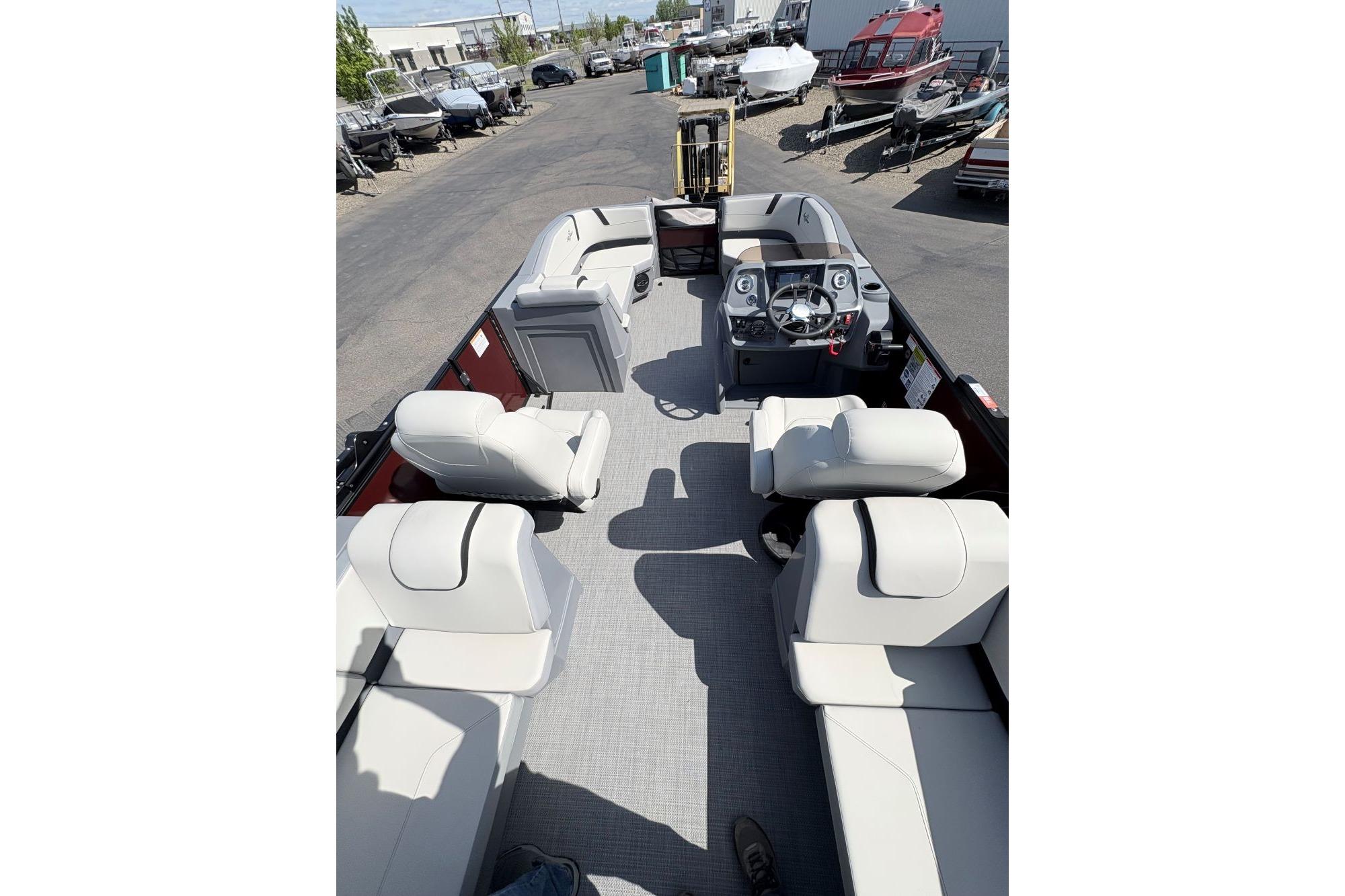 2026 SunChaser Lucerne 22 LR DH pontoon boat interior with plush seating and steering console.