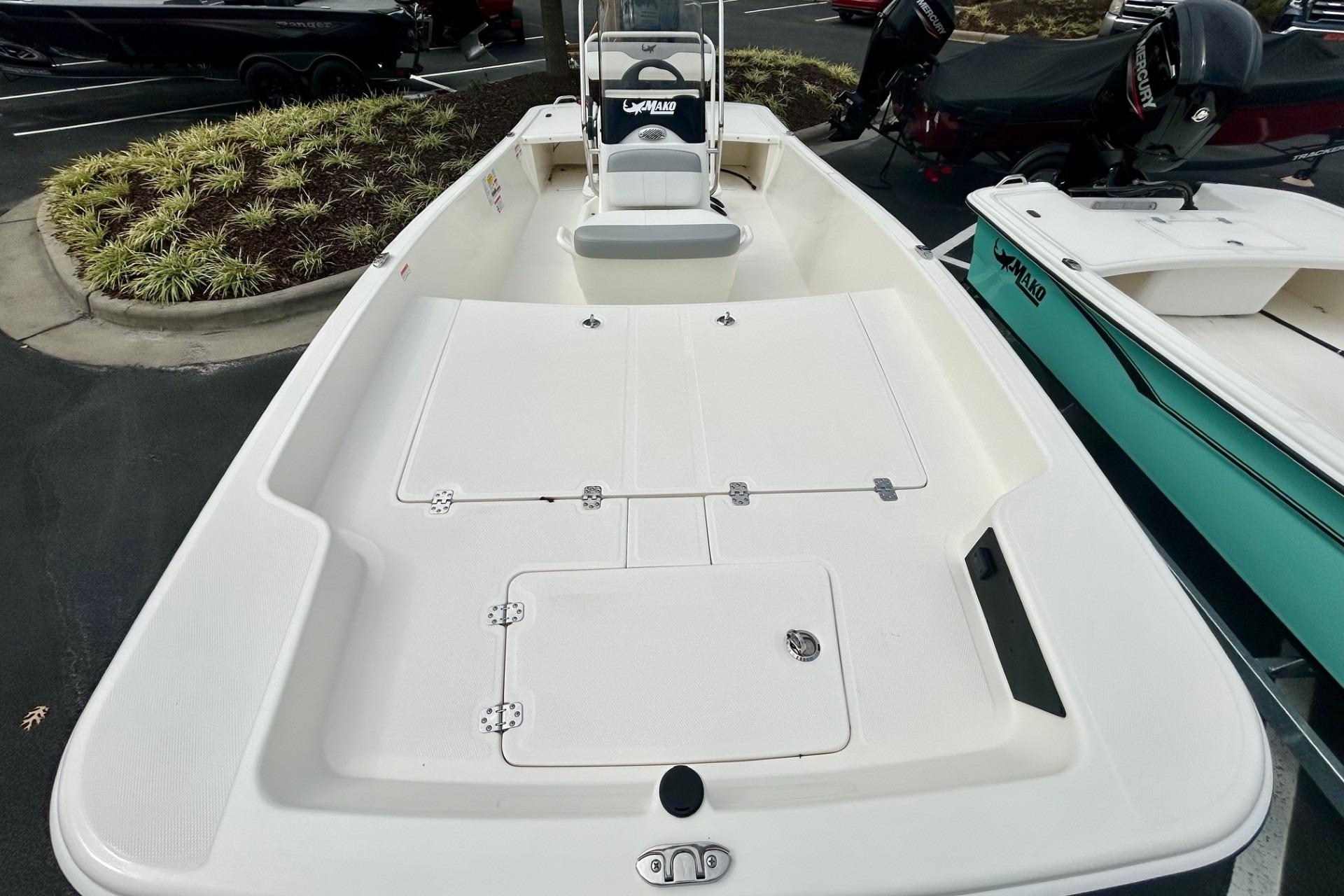 2026 Mako Pro Skiff 17 CC boat, spacious deck, white finish, parked outdoors.