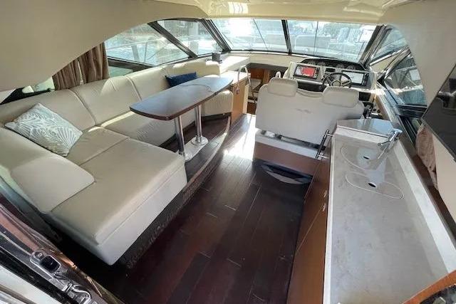 Luxurious interior of 2016 Sea Ray Sundancer 510 yacht with plush seating and modern helm.