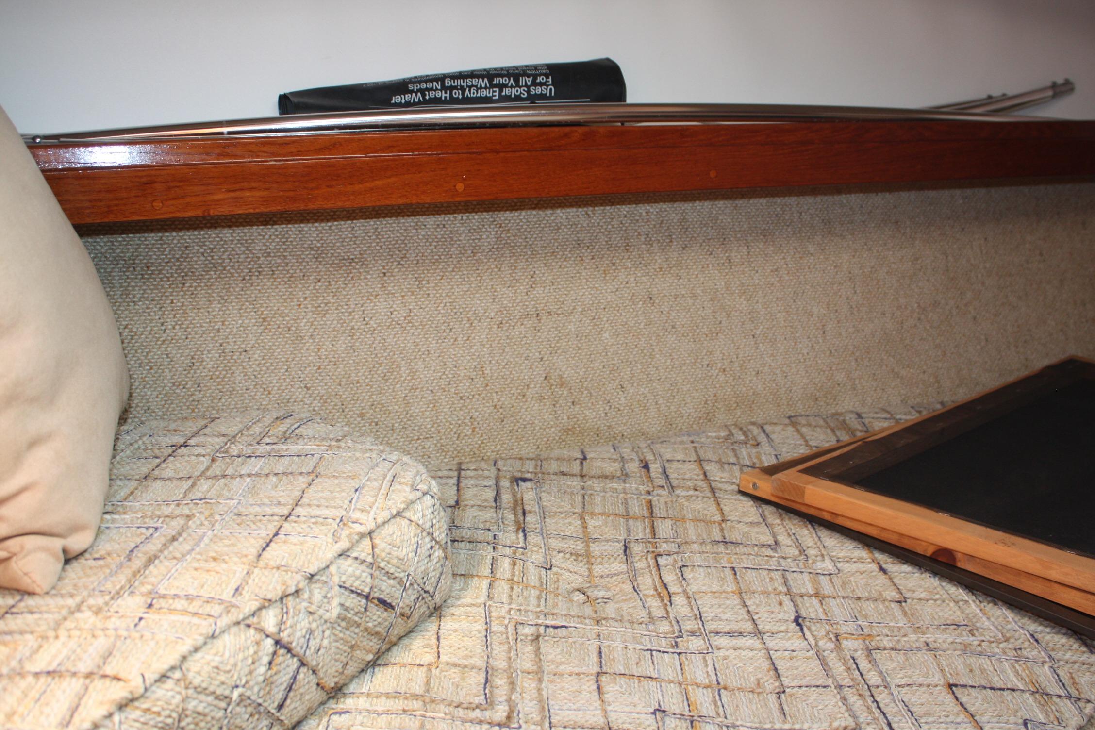 Interior cabin of 1981 S2 9.2A sailboat with cushioned seating and wooden trim.