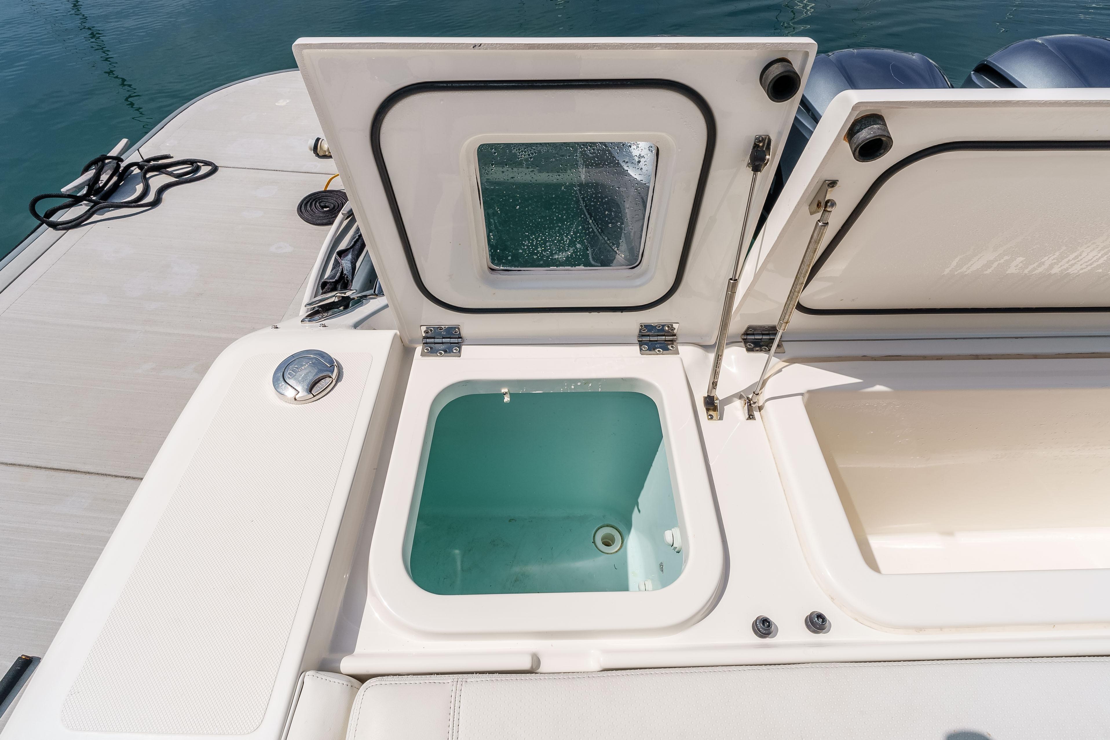 2022 Pursuit OS 385 Offshore boat with open storage compartments on deck.
