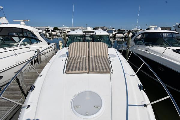 2010 Cruisers Yachts 390 Sports Coupe docked with sun loungers on deck.