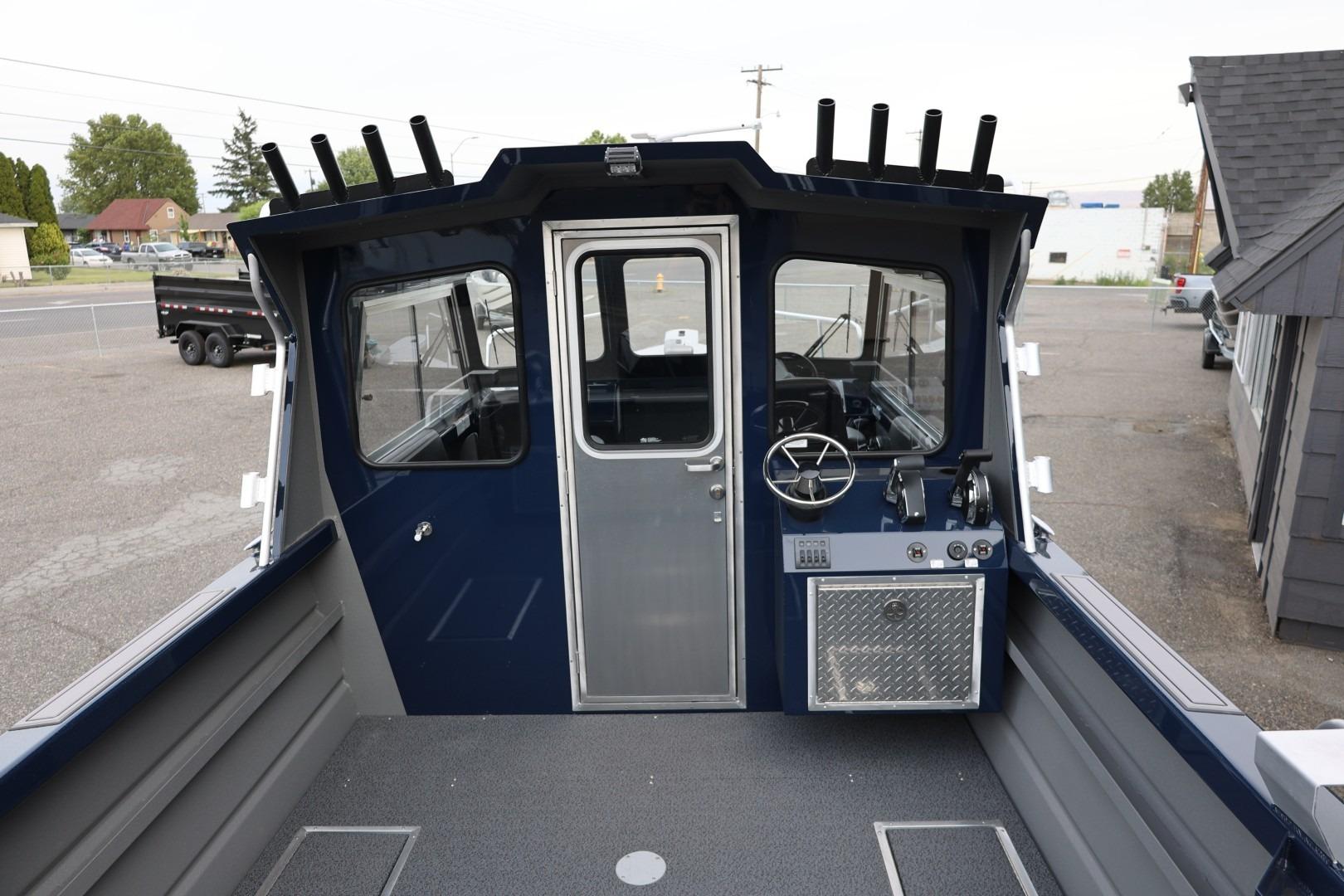 2026 Thunder Jet 24 Alexis Pro boat interior with steering wheel and control panel.