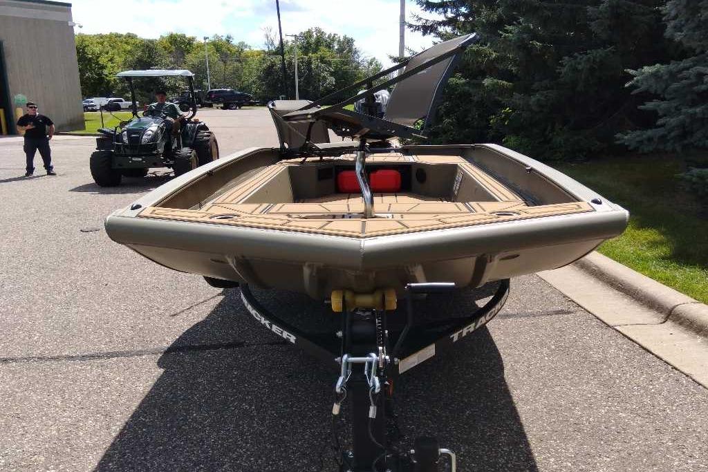 2026 Tracker Grizzly 1650 T Prairie Wings Edition boat on trailer, parked outdoors.